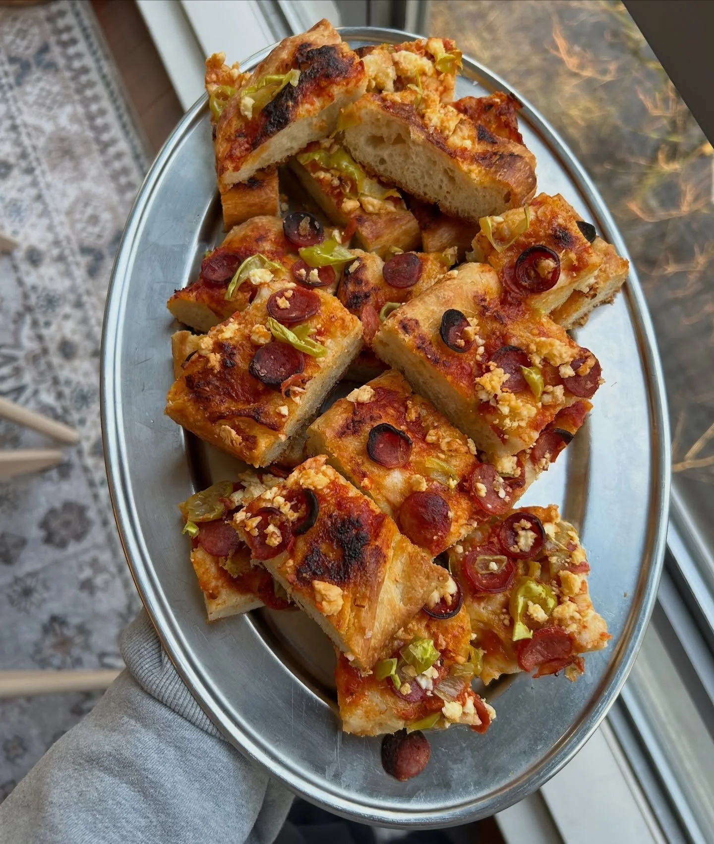 Festive loaded focaccia with pepperoni cups, feta, pepperoncini, parm and tomato ✨