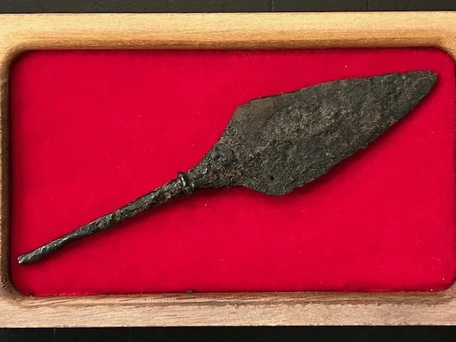AD 850-1000. Well forged, tanged arrowhead. 4.03” in length, triangular form point, near flat both sides. Elegantly cusped bottom and thickened foot base to seat in the shaft and tapered tang. Such arrowheads were commonly used on raids.