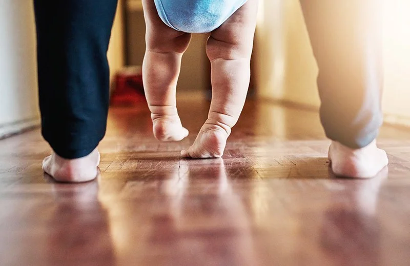low-section-people-walking-hardwood-floor.jpg