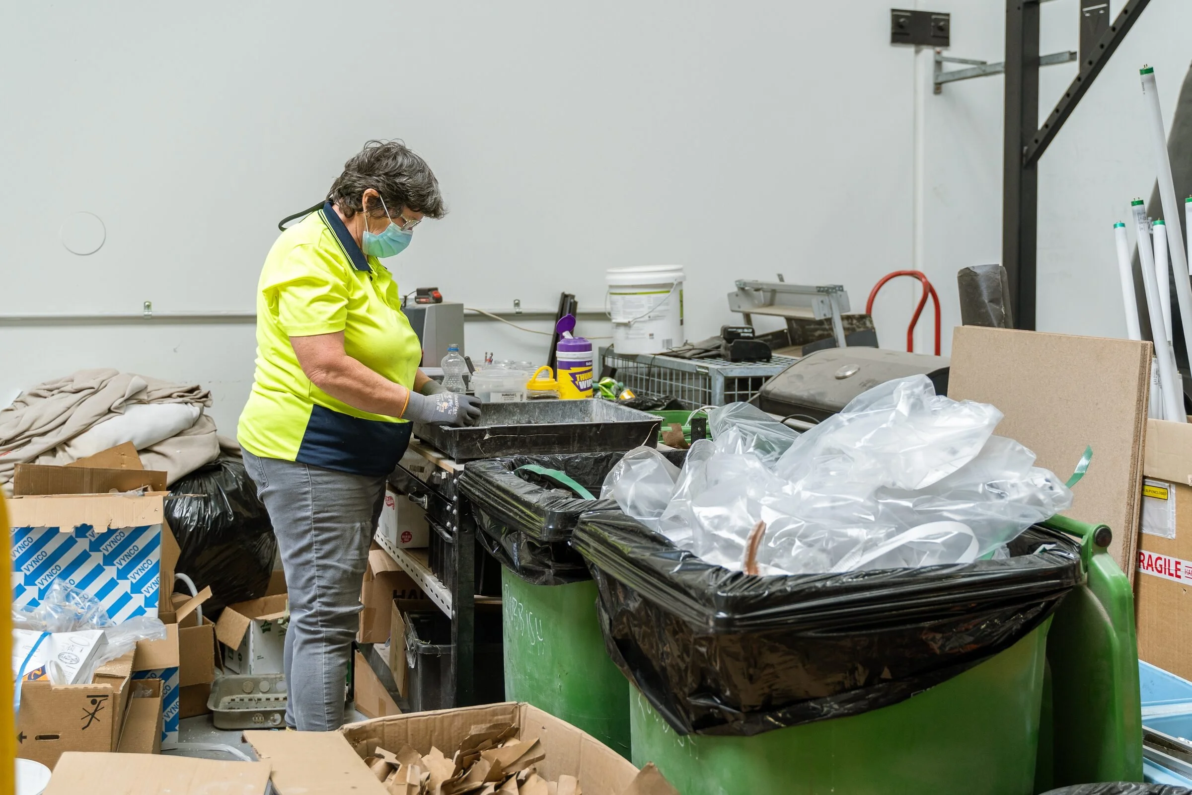 Lindsay sorting recycling at the Shox workshop bench