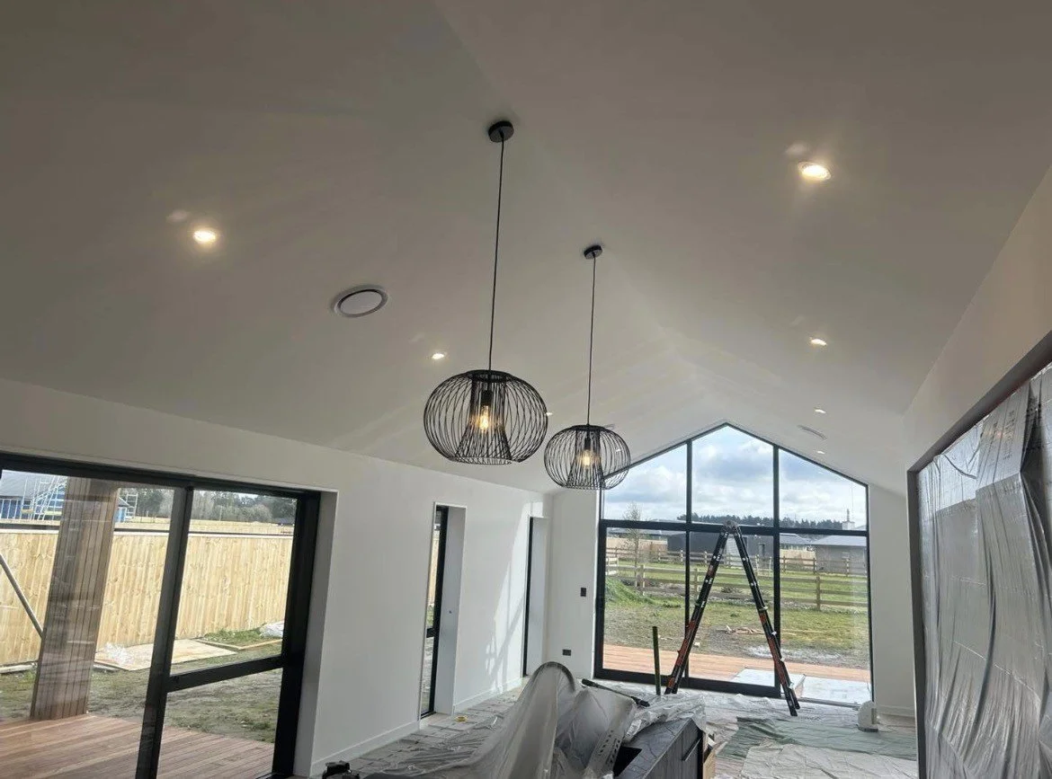 Black wire pendant lights and LED downlights installed by Shox Electrical in a new Canterbury home