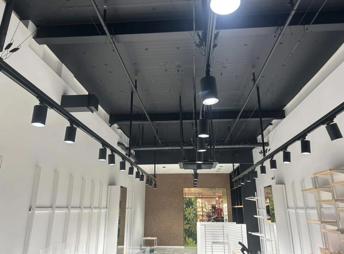 Black track lighting installed by Shox Electrical in a Christchurch retail store