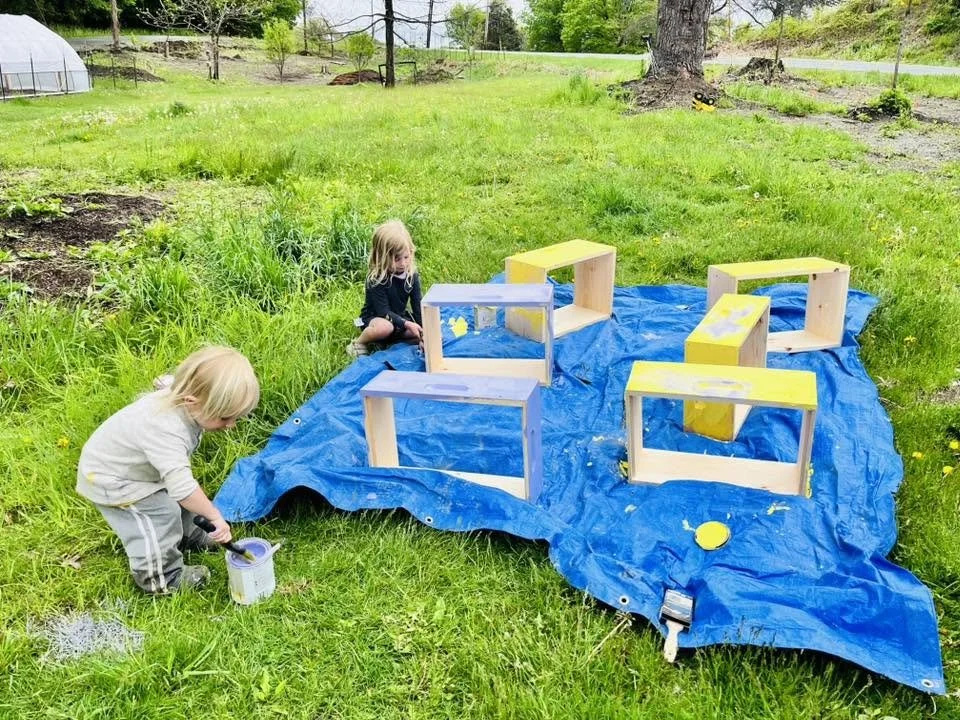 The kids painting bee boxes (2 and 5)