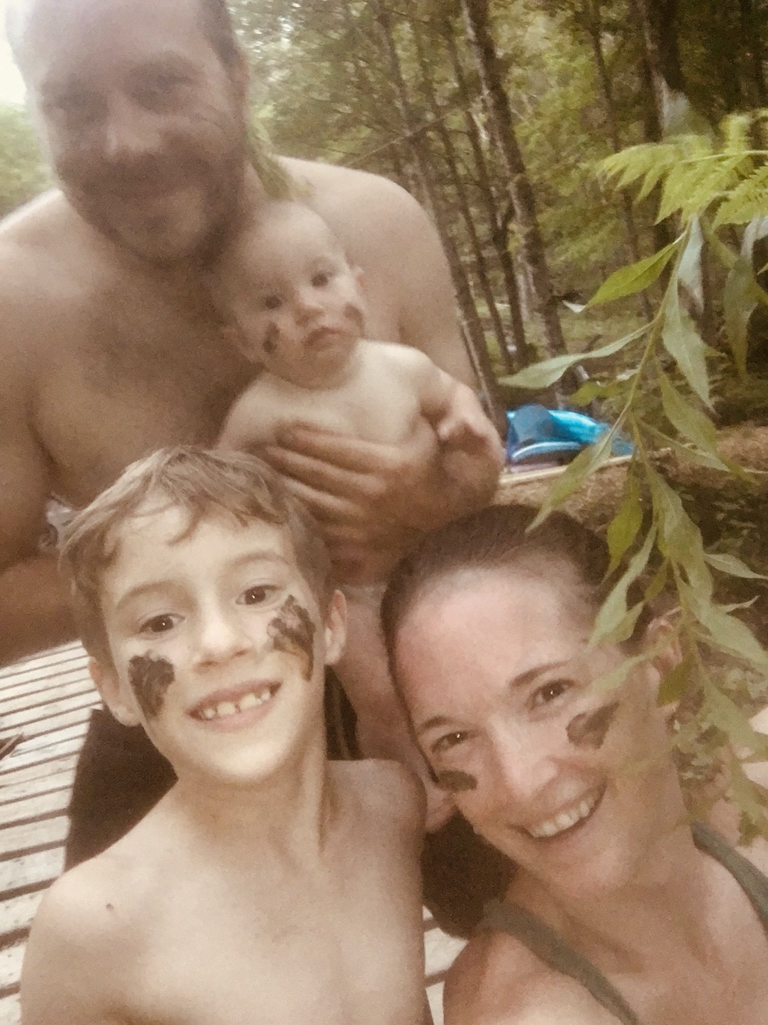 One of our first days living off grid, with faces painted with mud