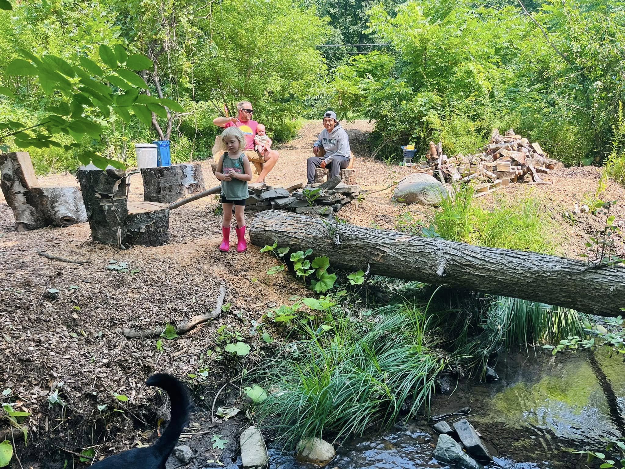Michael, Norberto, and Myka hanging out at our stream. Michael made the chairs from trees on our property!