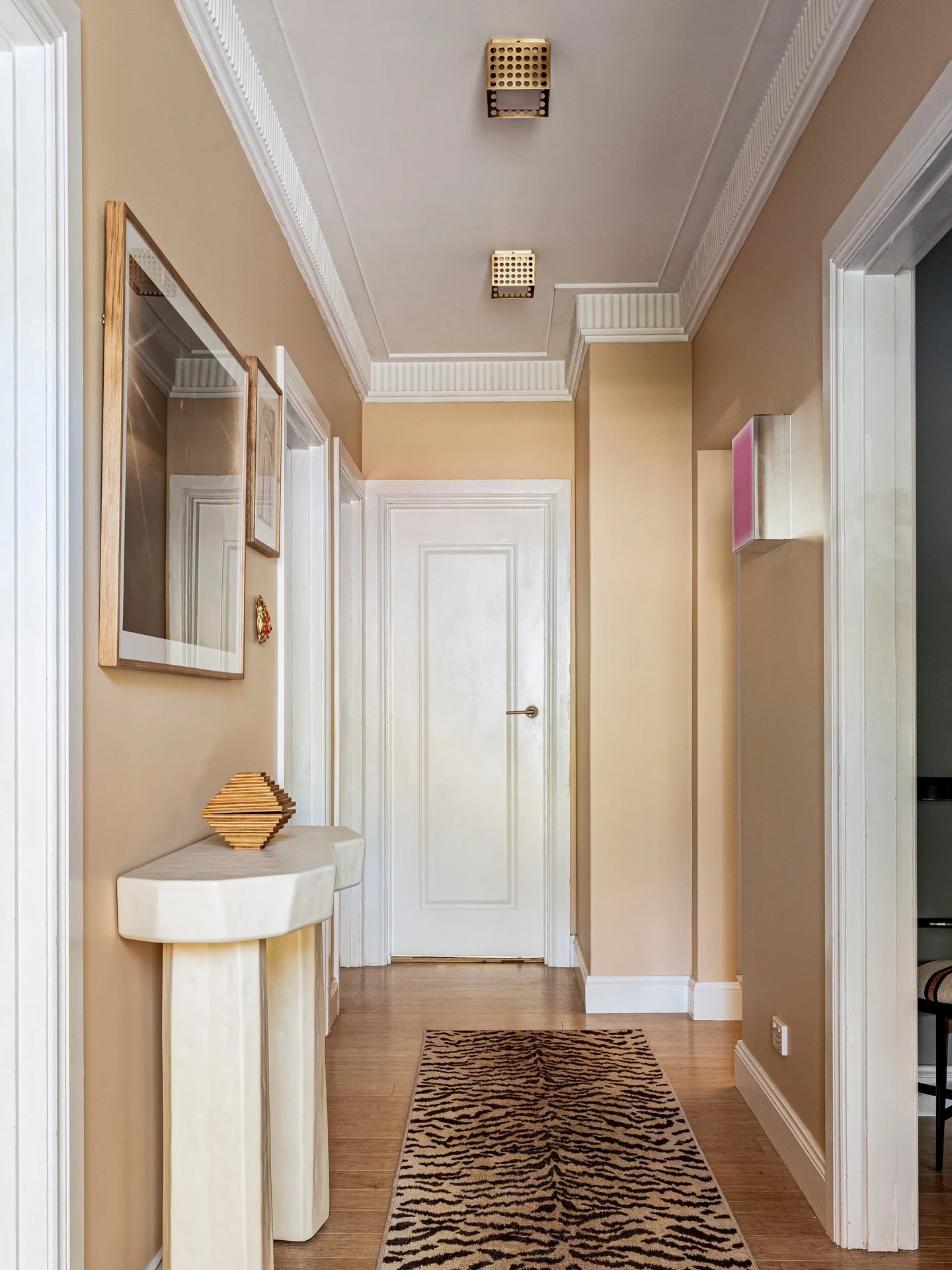 MY HALLWAY. 

Glow up in the hall! I used the @bloomingdaleslighting Kelly Wearstler ceiling lights and @francescaowen_ artwork as my jumping off point - warm golds and glowy lighting. The runner is a bit of (washable) fun and brings the drama. She n