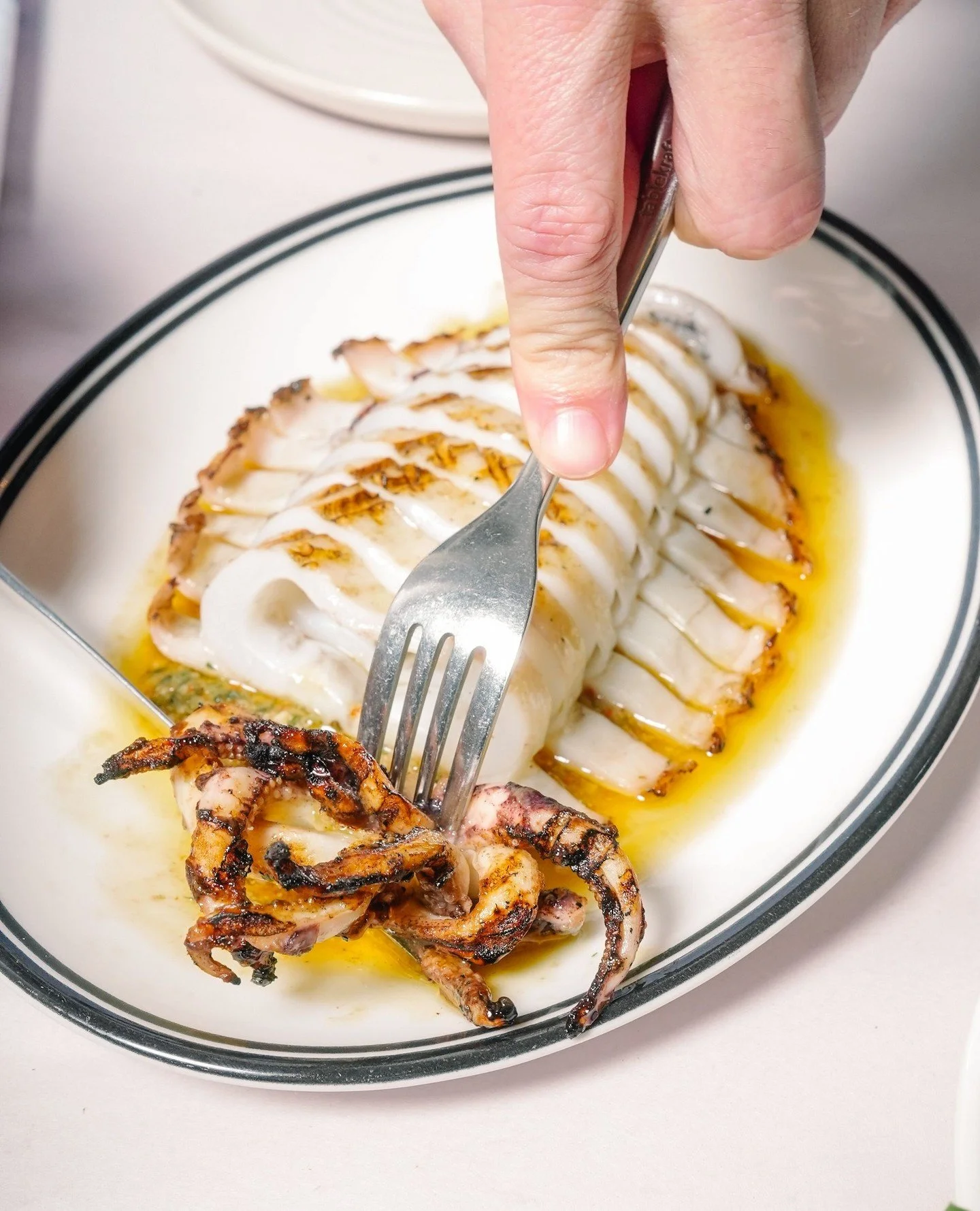 Grilled calamari, sliced and served with green olive salsa and fresh lemon. A taste of the coast in spring.⁠
⁠
#Ronnies #RonniesMelbourne #GrilledCalamari #SpringMenu #MelbourneFoodies #MelbourneCBD #Rialto