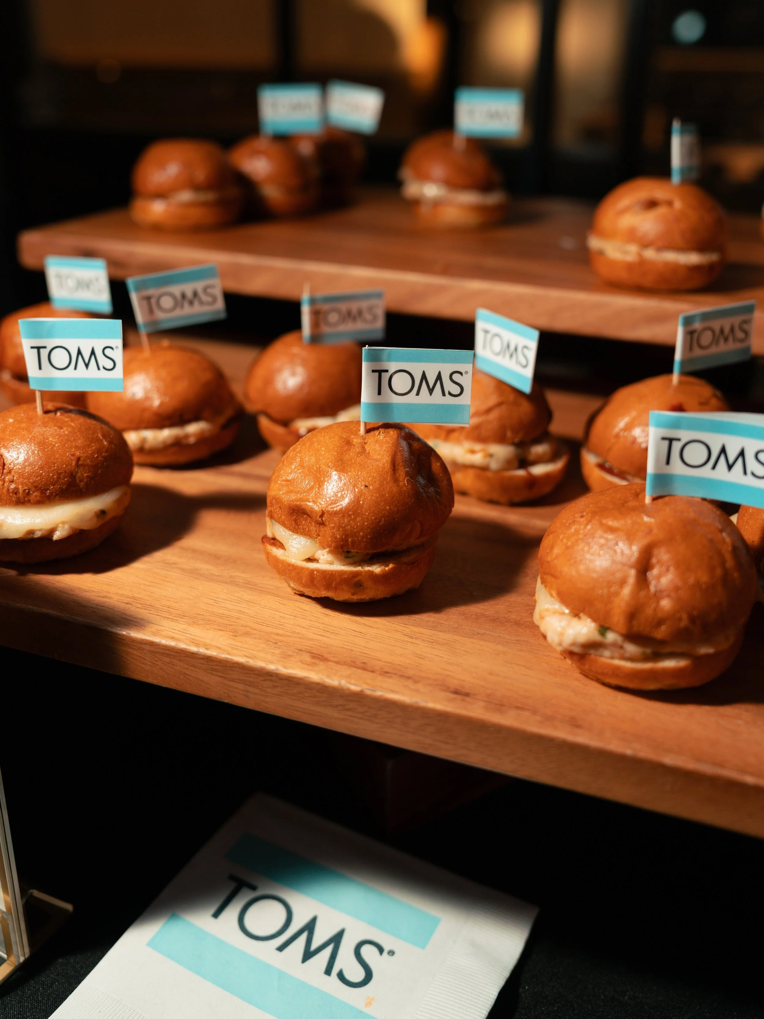 Custom branded sliders showcase Paloma Venice's private event catering, perfect for corporate gatherings, holiday parties, product launches, and celebrations.