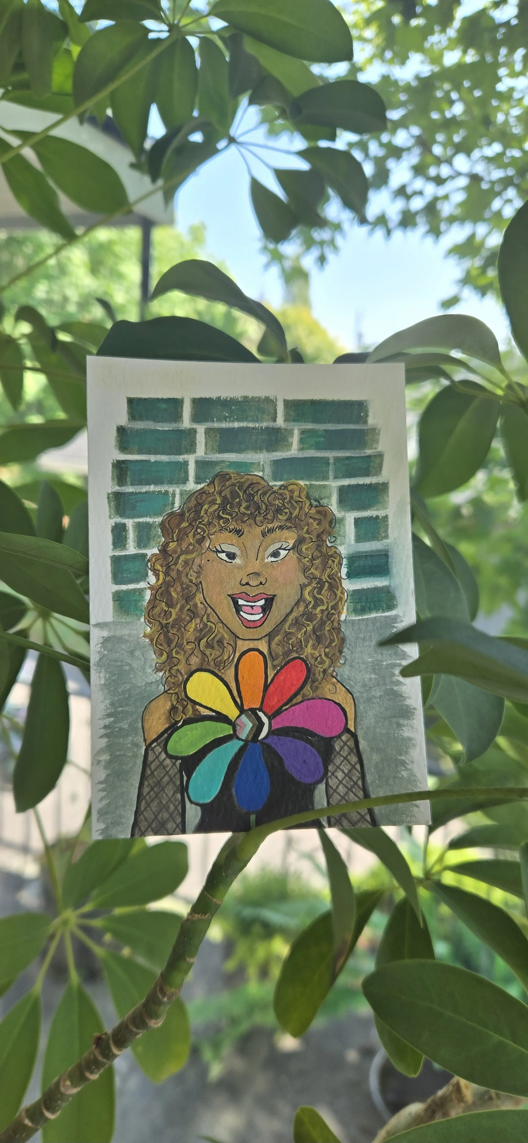 A hand-drawn illustration of a woman with curly hair, holding a colorful flower with rainbow petals, against a background of a brick wall.