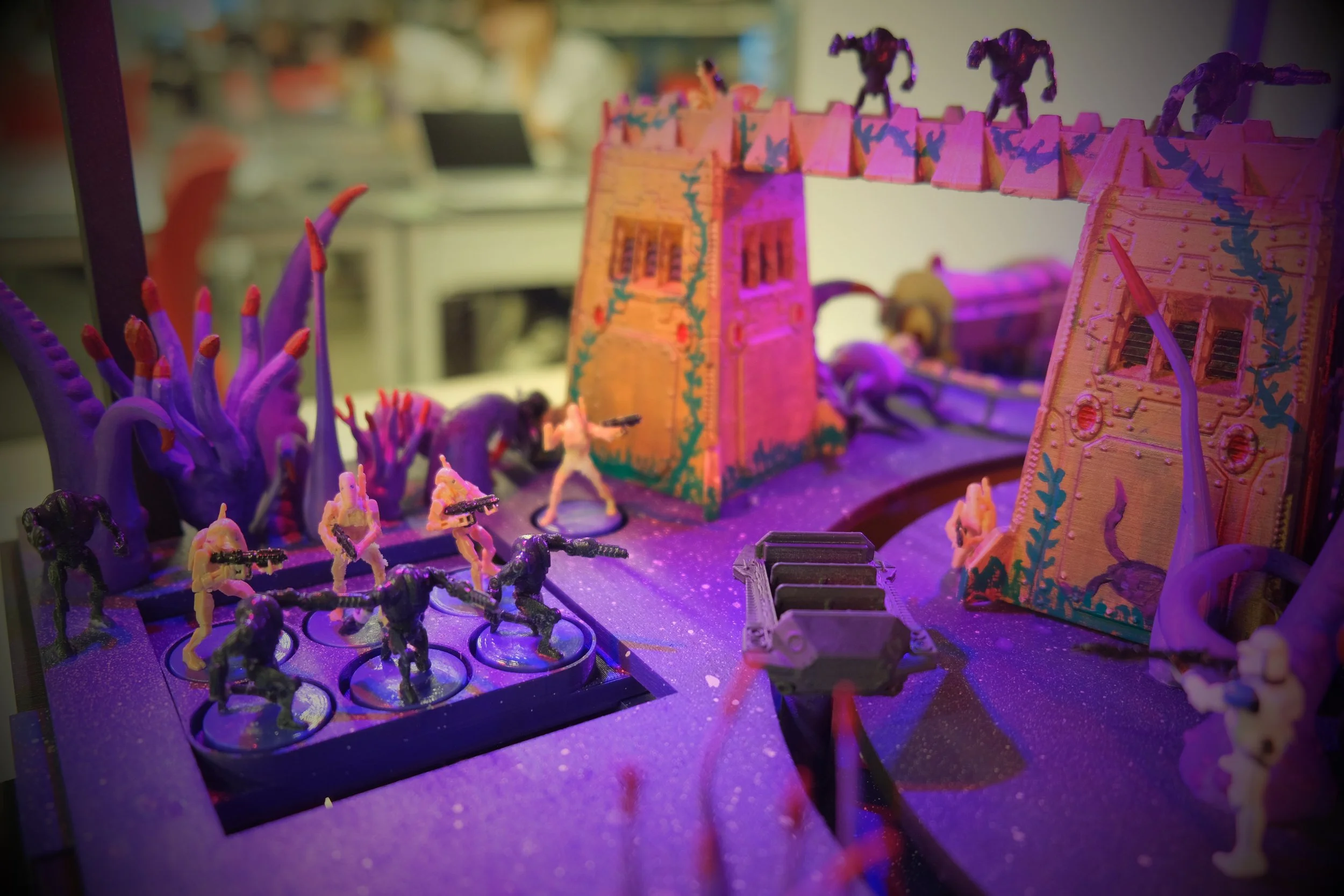 Miniature toy soldiers in battle with a castle and mystical plants under colorful lighting.