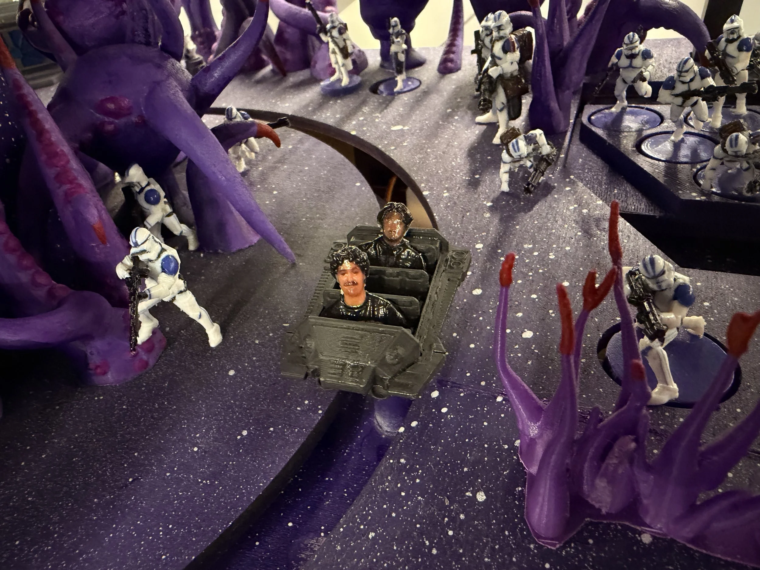 Miniature Star Wars clones, purple alien plant, and space-themed background.