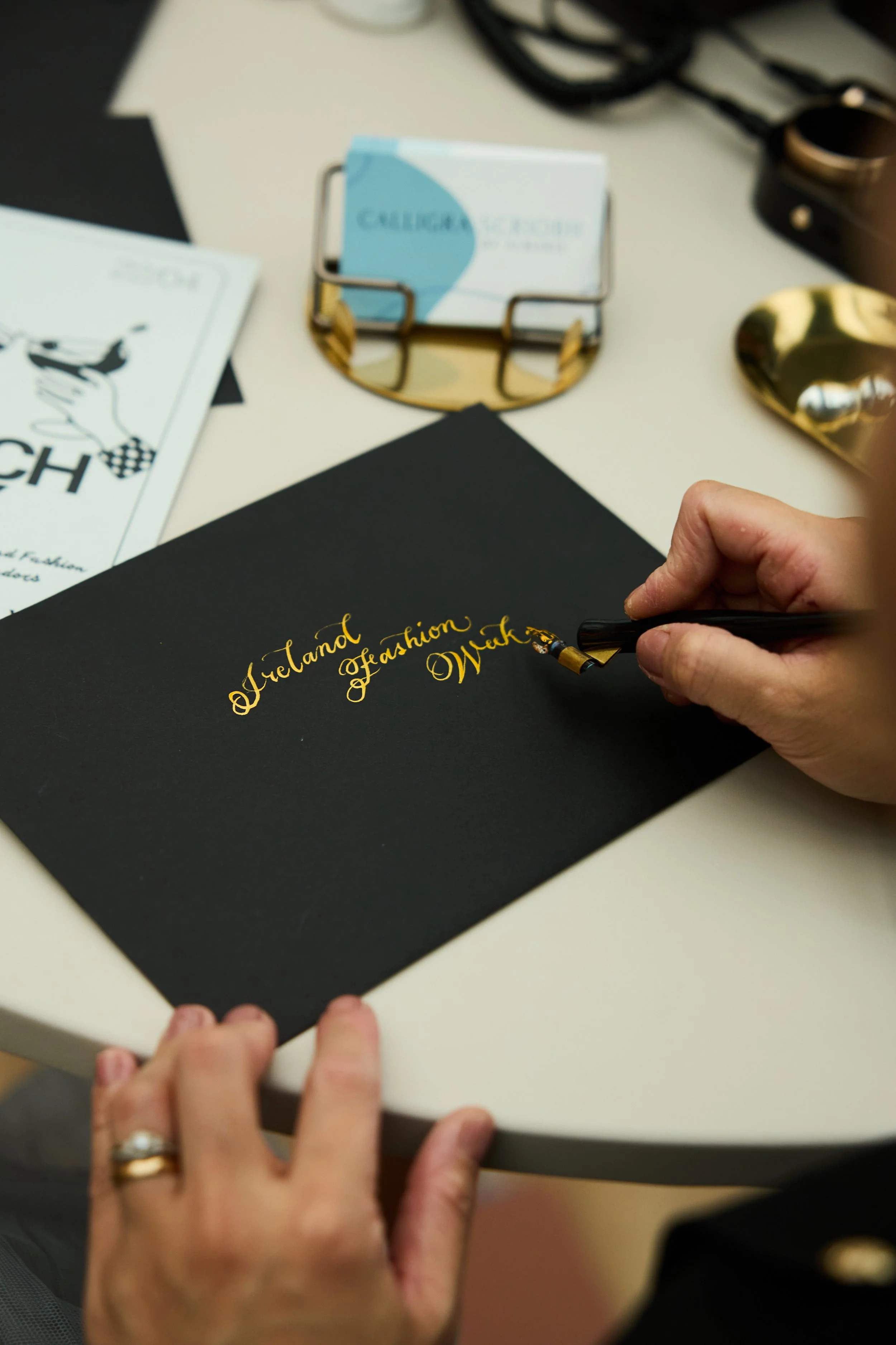Ireland Fashion Week Dublin calligrapher Ireland calligrapher UK calligrapher EU worldwide calligrapher, engraver painter, brand activation, experiental marketing, live event, live art,  PR launch event personalisation wedding calligrapher business n
