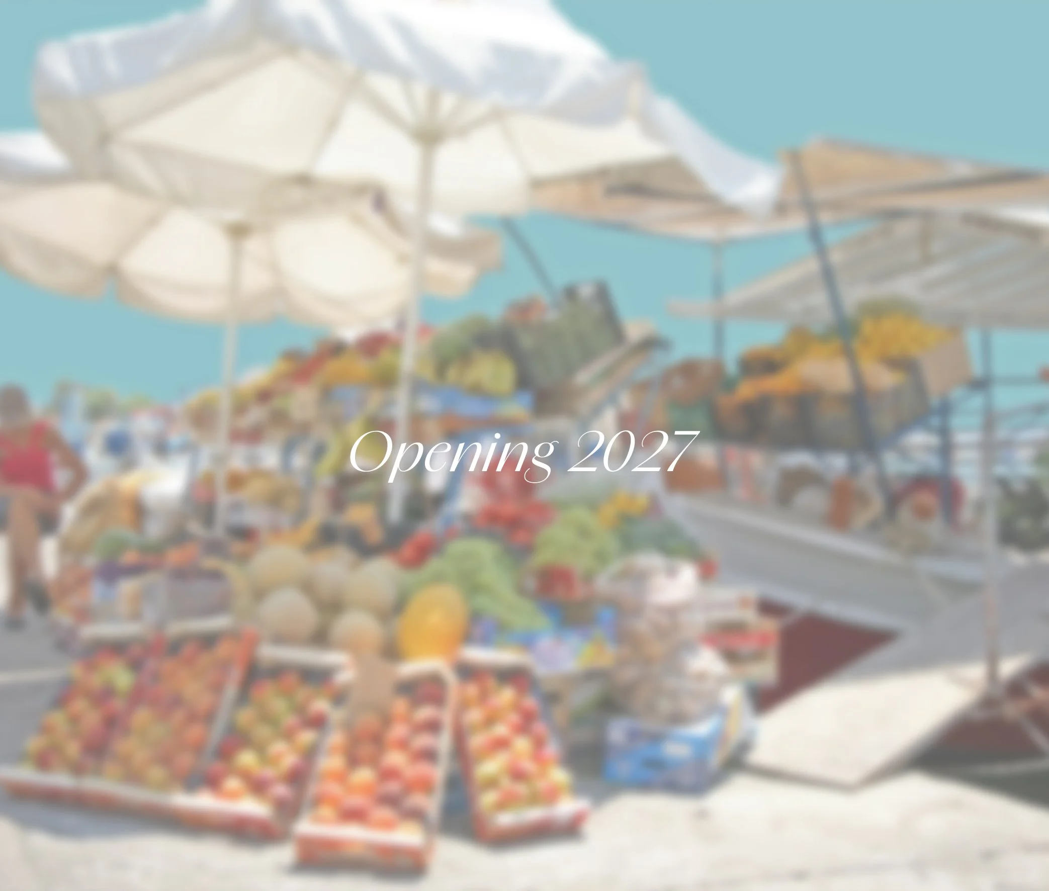 Blurred outdoor farmers market with stalls of fruits and vegetables, white umbrellas, and people shopping, overlaid with text 'Opening 2027'
