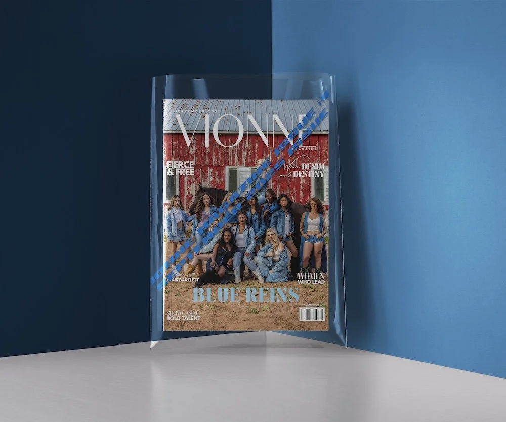 A magazine titled 'VION' with a group of women in denim clothing on the cover, enclosed in a transparent plastic sleeve, against a two-tone blue background.