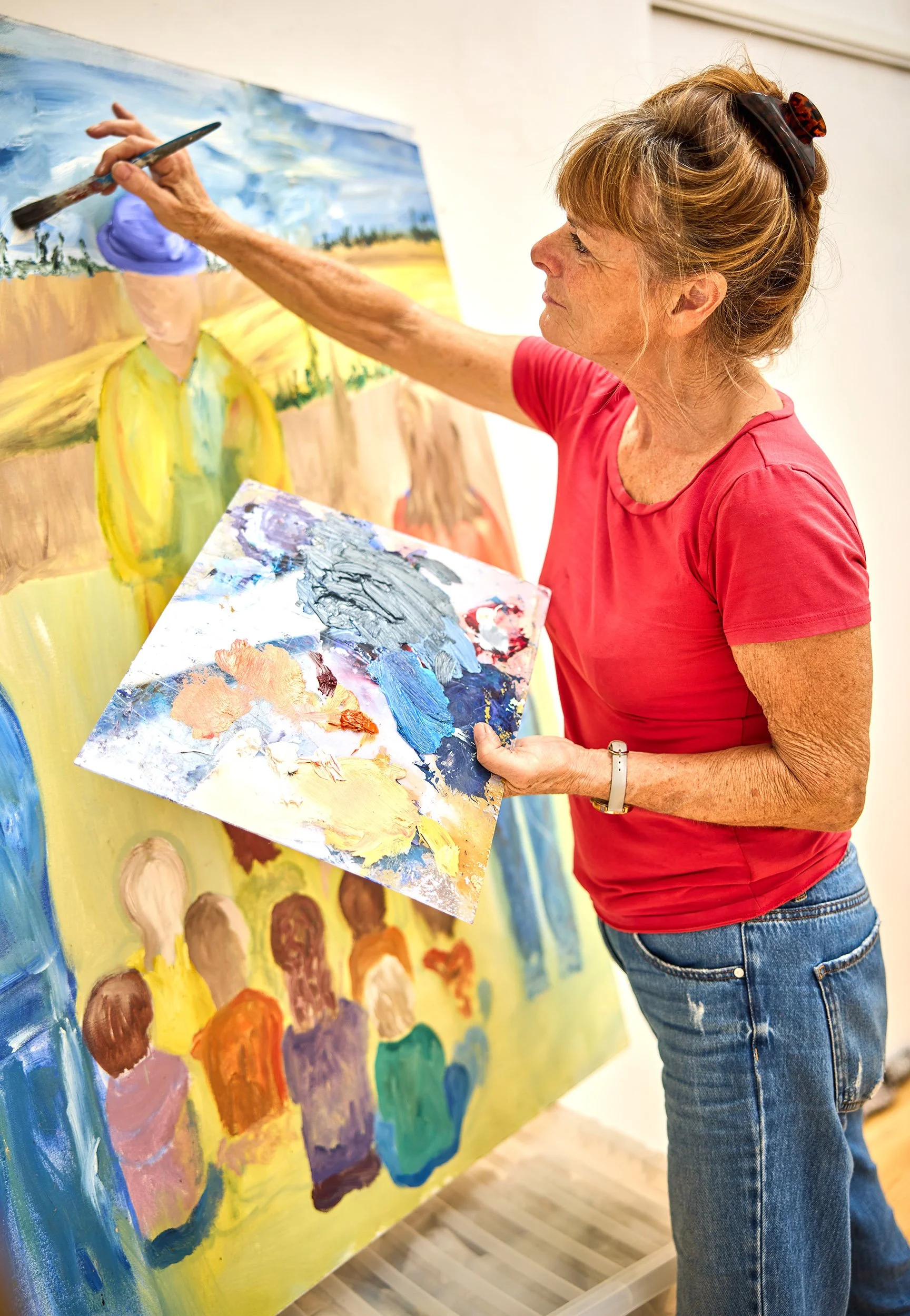 Sherry Forth artist, putting the final touches to her artwork, before Charles Ward photographs it.