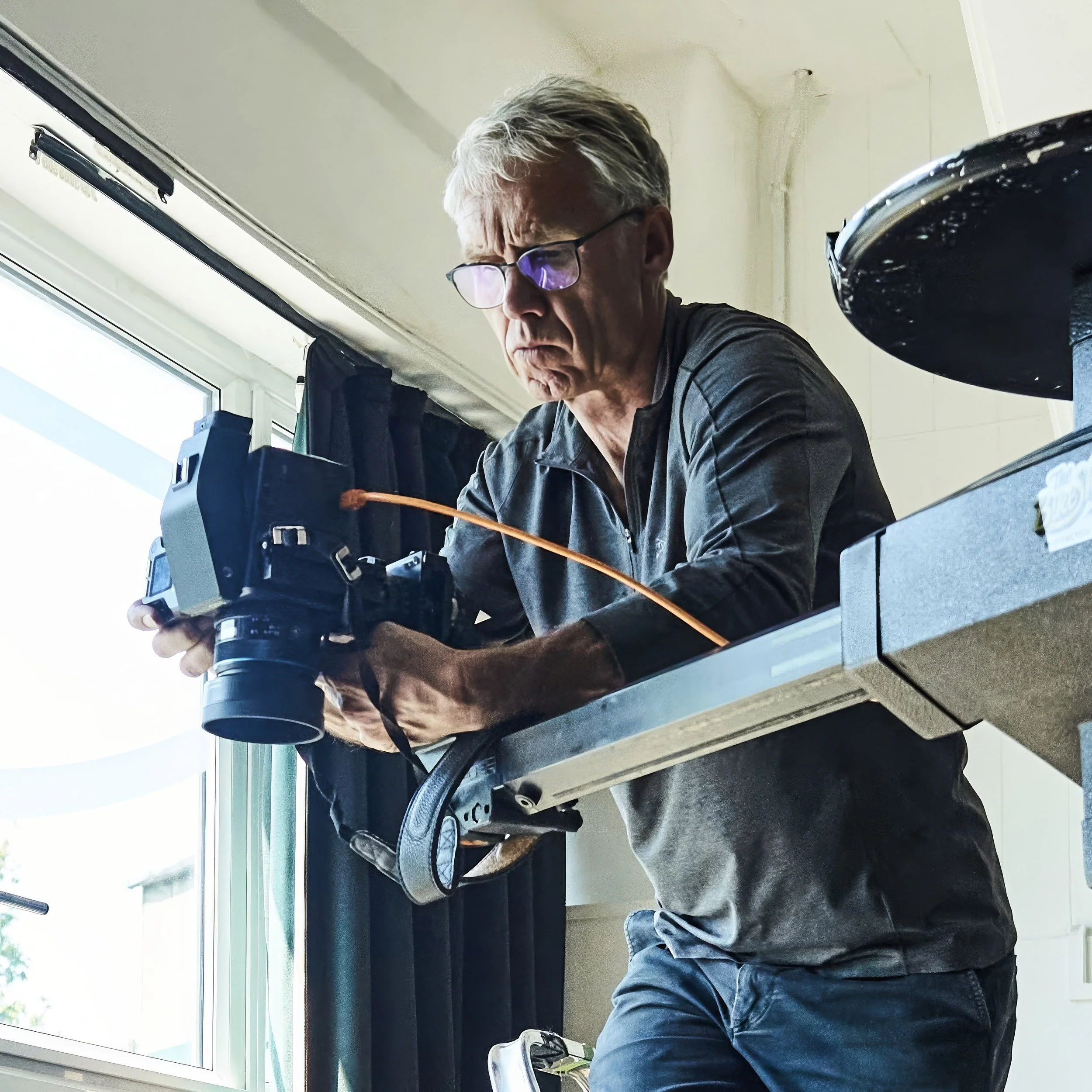 Charles Ward taking photographs with a Phase One digital camera at Farm Studios, Earls Barton.