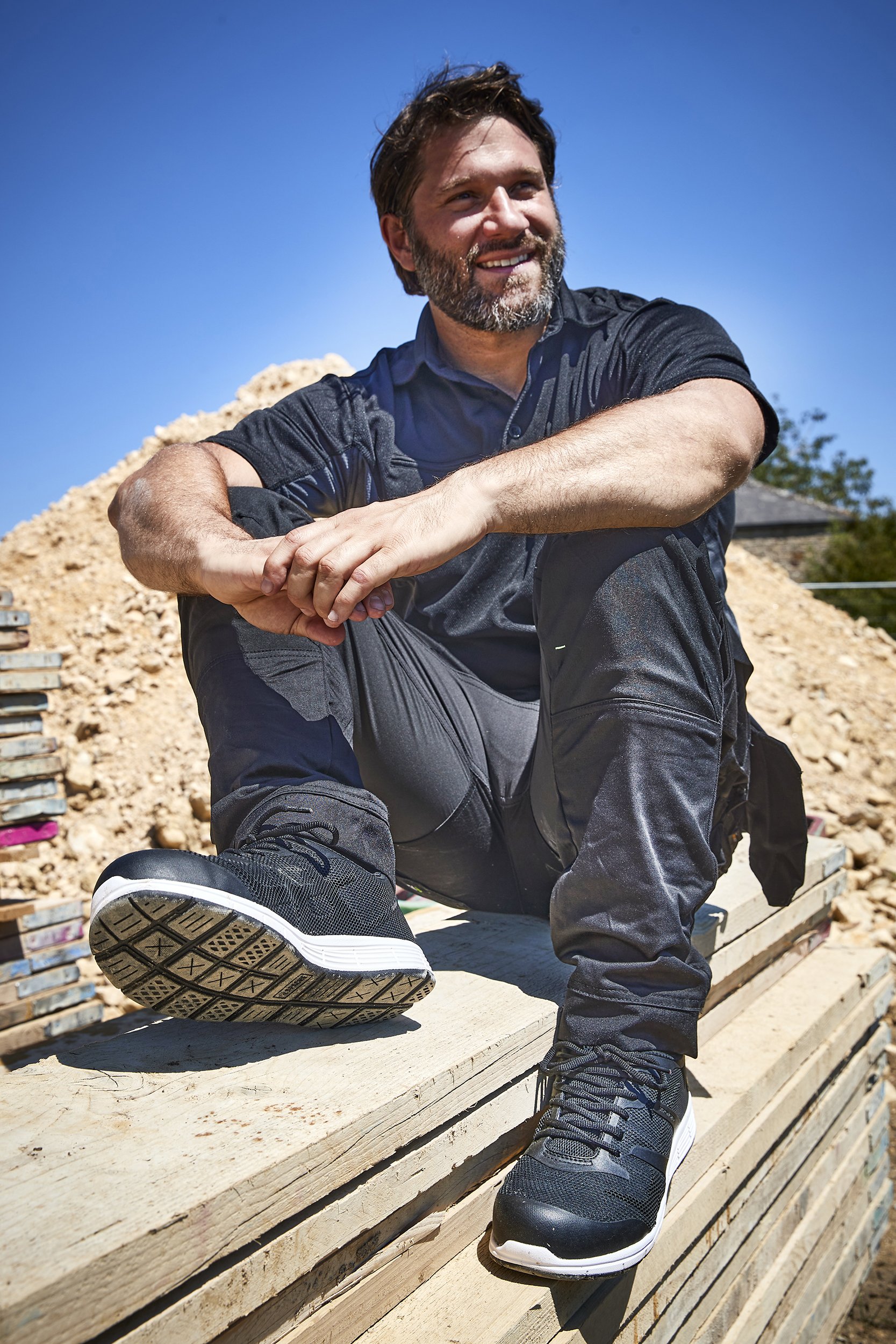 Charles Ward's photograph of a model wearing Sterling Safetywear's clothing and boots on a location photoshoot in Northamptonshire.