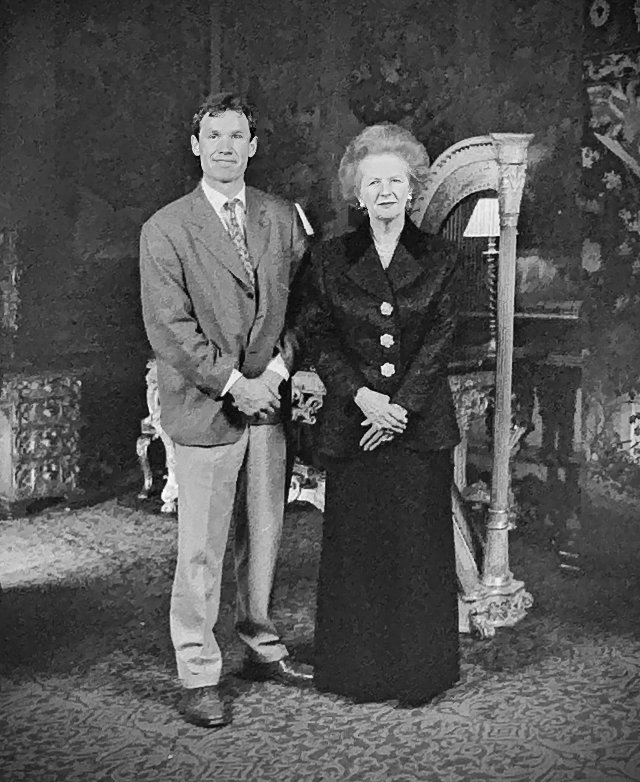 A young Charles standing next to Lady Thatcher at Castle Ashby House in Northampton