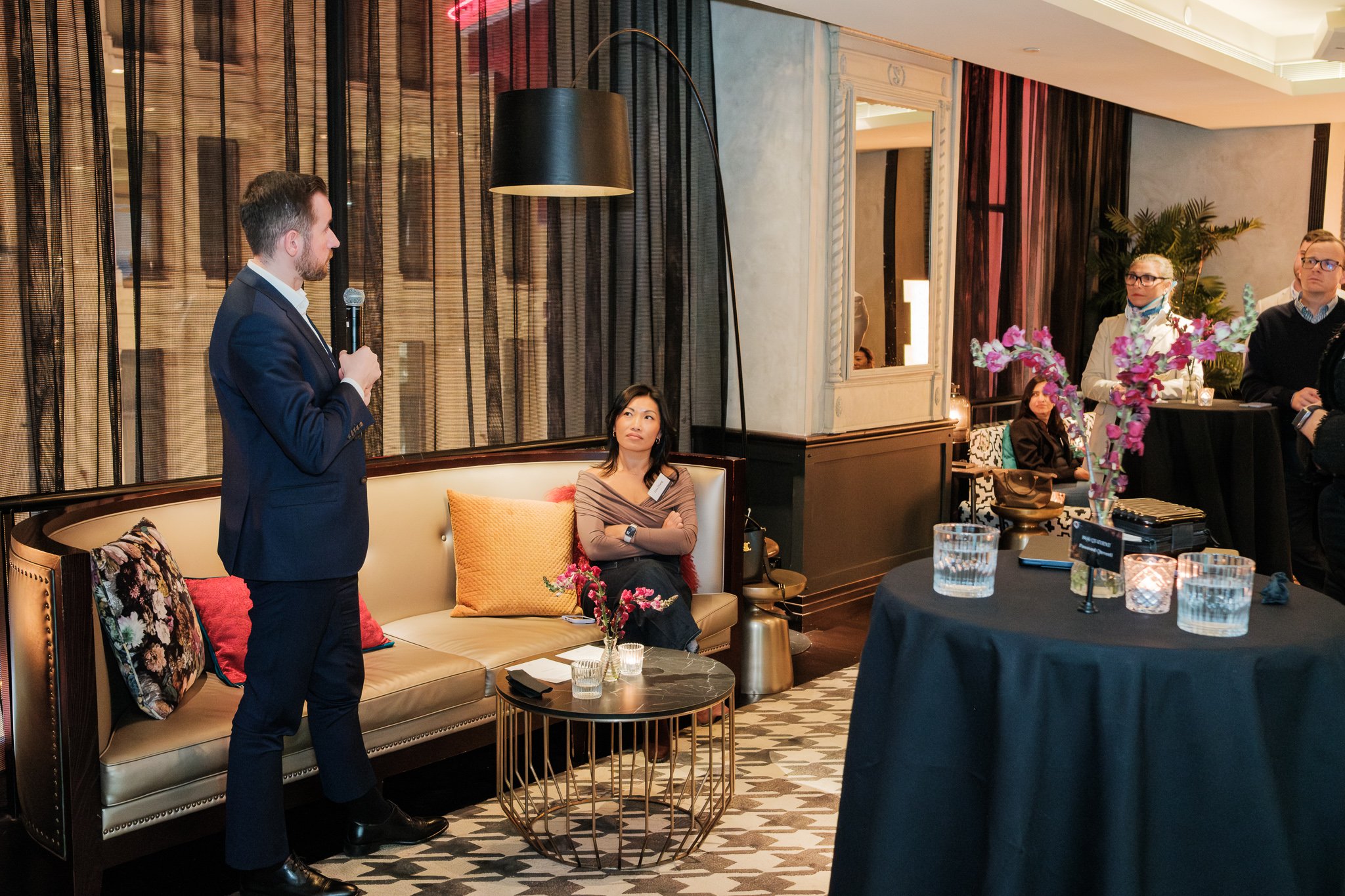 The presenter and the engaged audience in the same frame — one of the most valuable shot types for post-event communications.