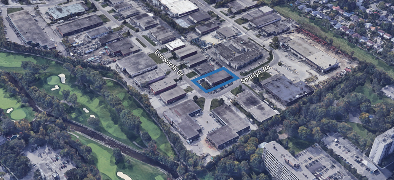 Aerial view of a commercial area with multiple buildings, parking lots, and a nearby golf course with green fairways and sand traps. A blue outline highlights a specific property at the intersection of Lenwoth Drive and Sharlyn Road.
