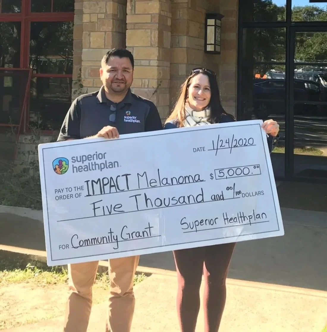 Bev and Superior Healthplan check presentation for a grant award