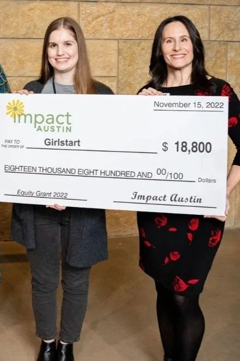 Beverly holding a large check at a nonprofit grant presentation as Interim ED