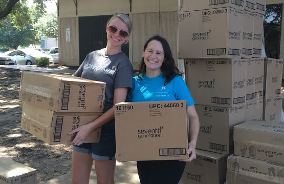 Beverly with volunteering holding boxes of donated diapers