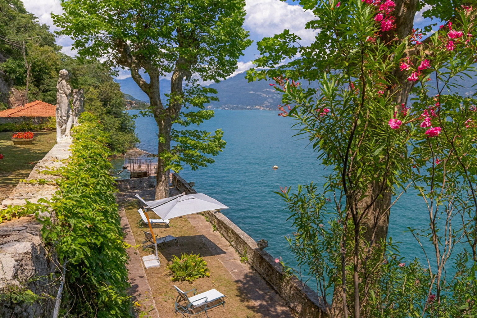 Lakeside Garden with Statue and Umbrella.png