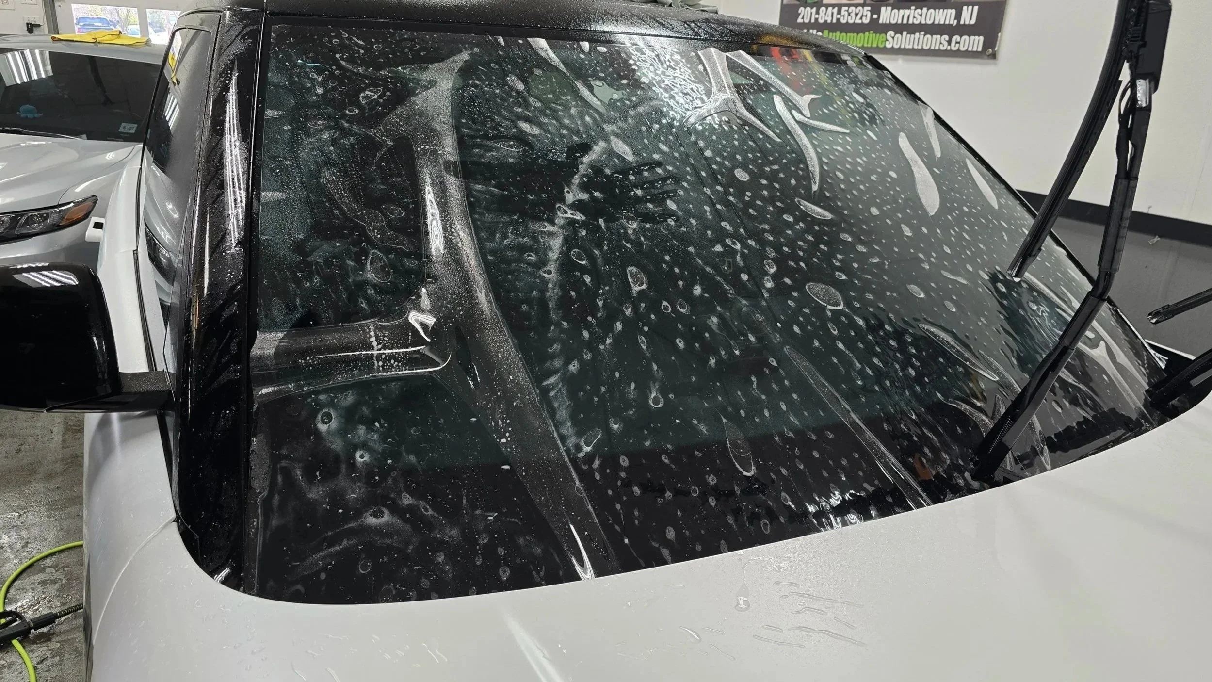 Xpel windshield protection film being installed to protect from roacks and debris