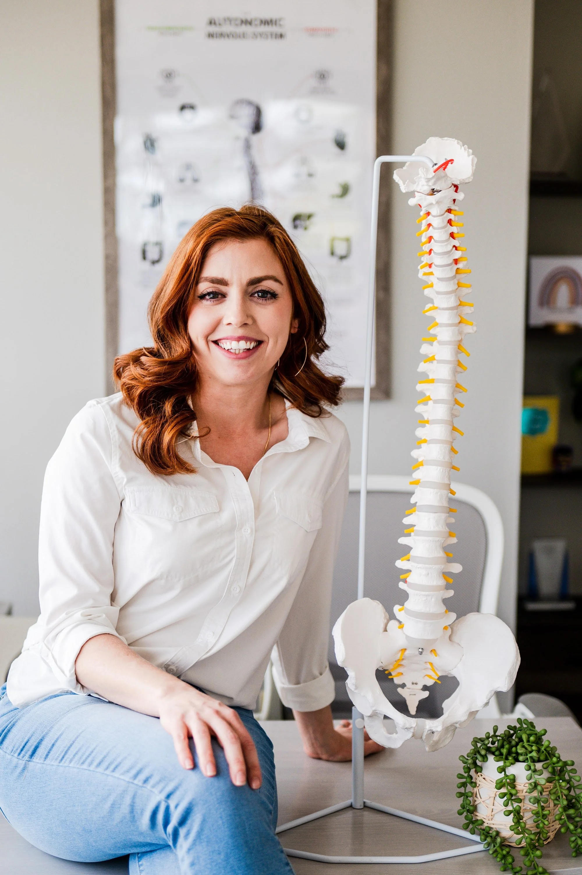 Dr. Shannon Bundy with a spine model at The Wellness Way Westminster
