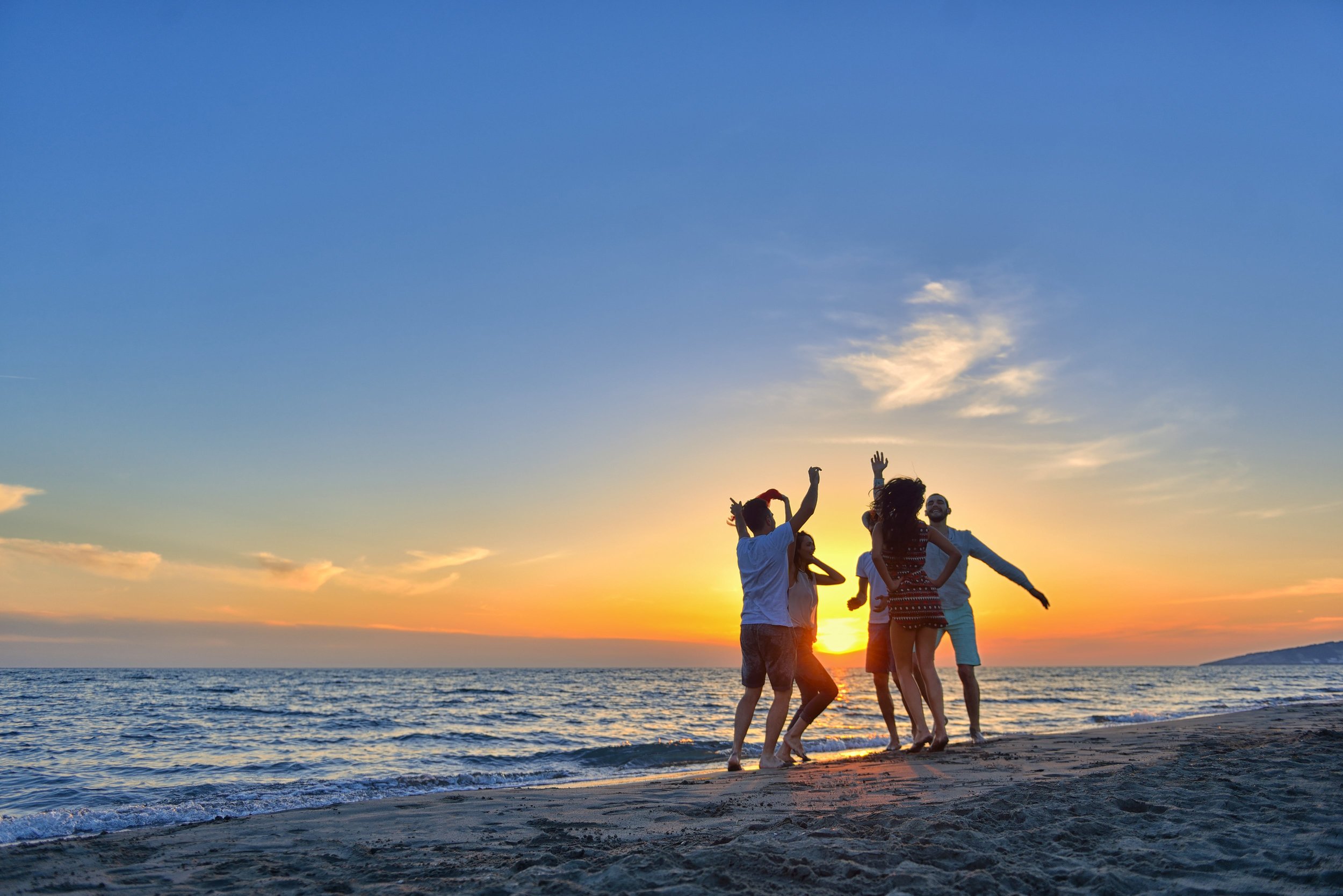 People jumping on beach