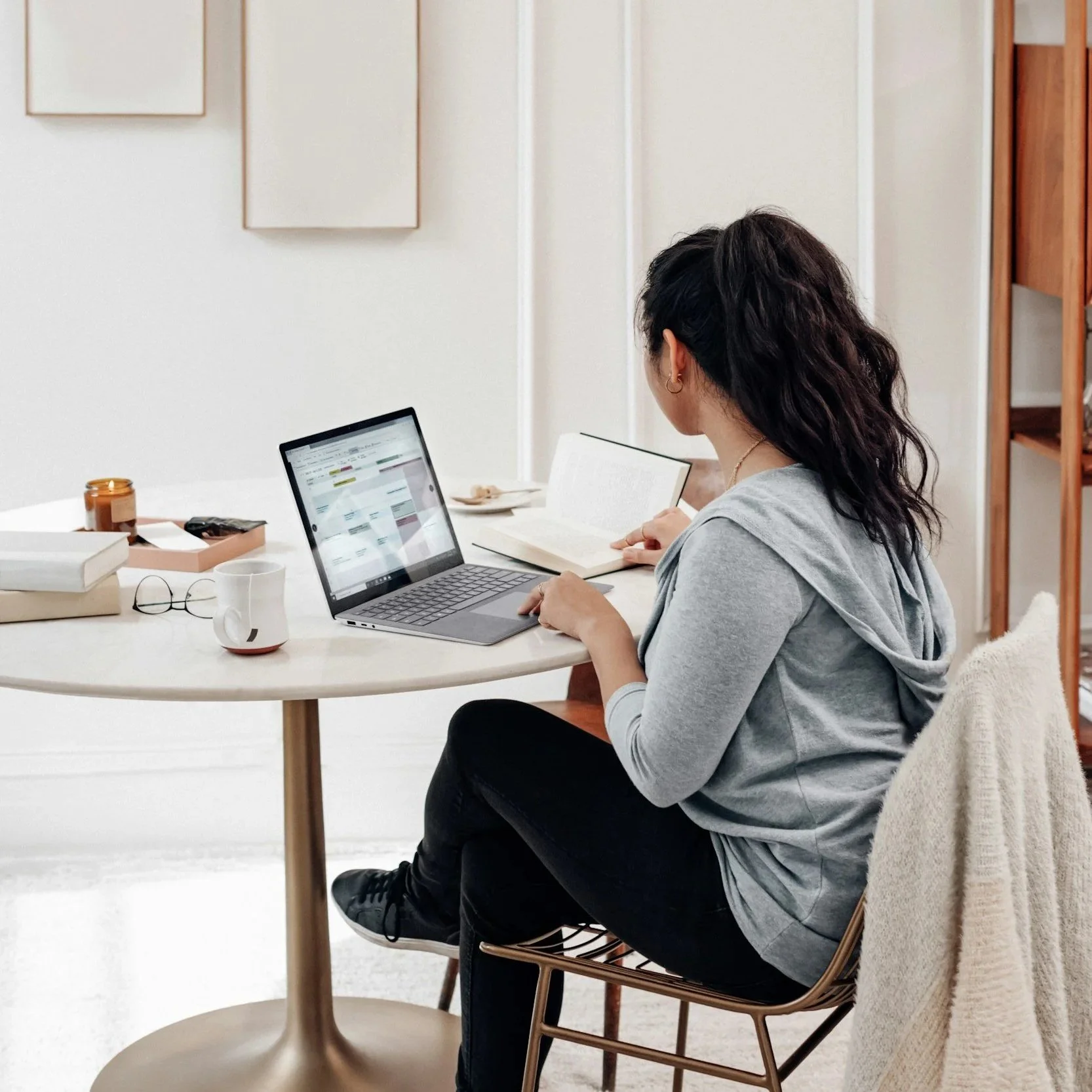 Girl working on her laptop while sitting at a table