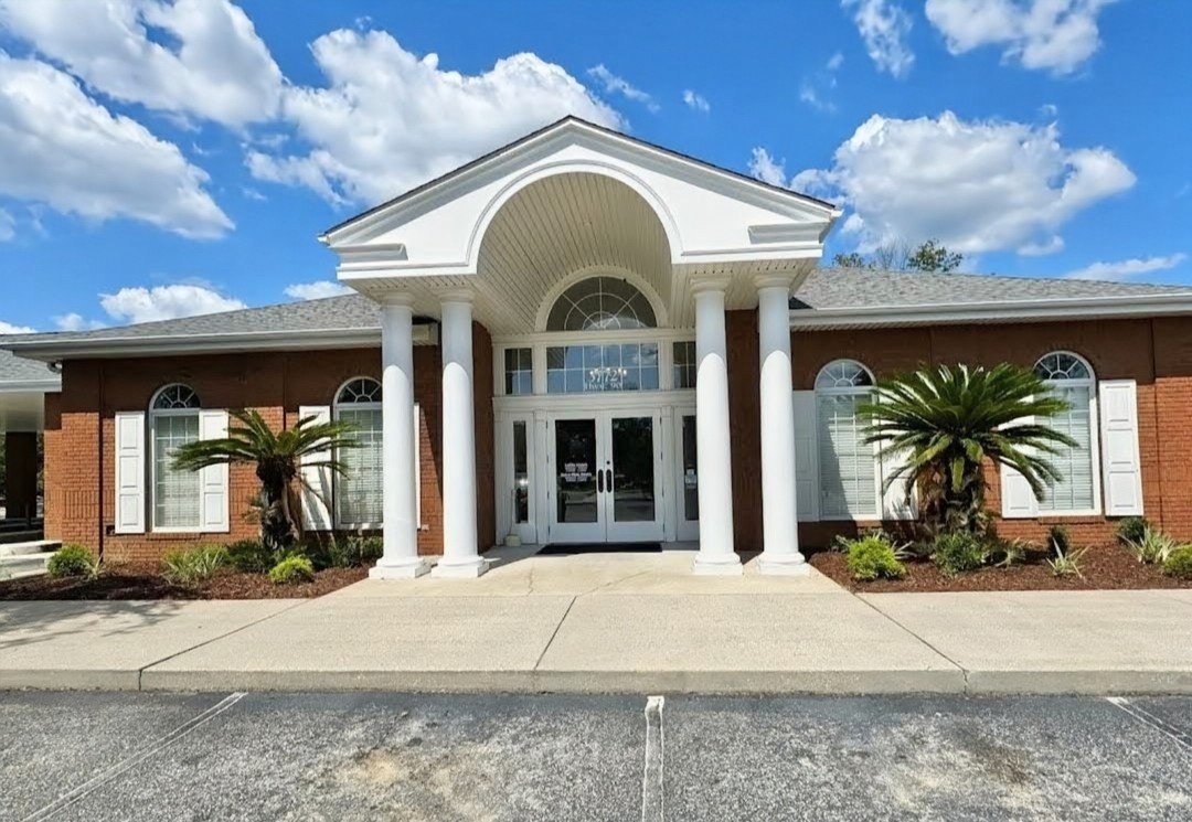 Exterior of Santa Rosa County Federal Credit Union Pace Branch on Highway 90 in Pace, FL, a brick building with white columns and arched entryway.