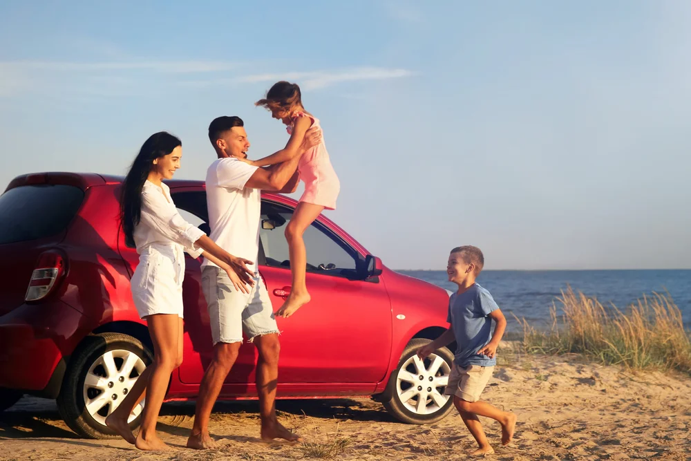Family enjoying time near vehicle