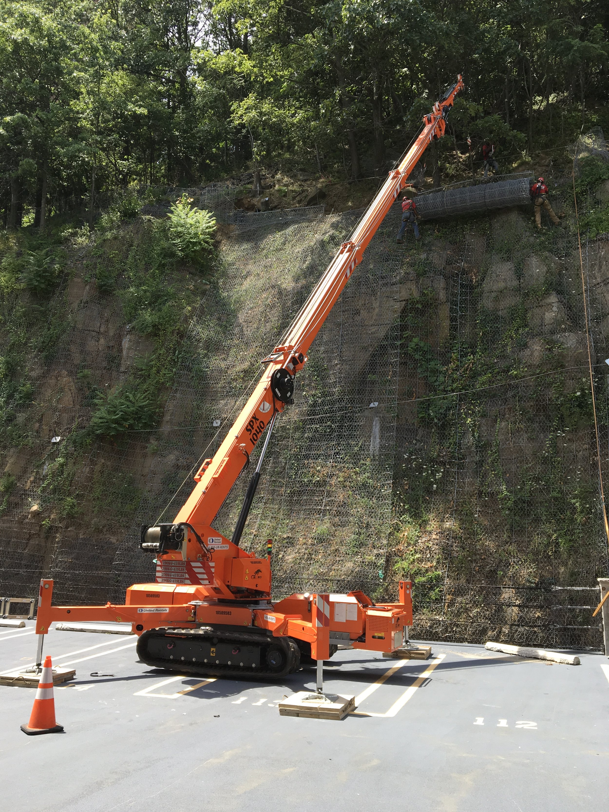 Spider Crane rigging nets up a cliff