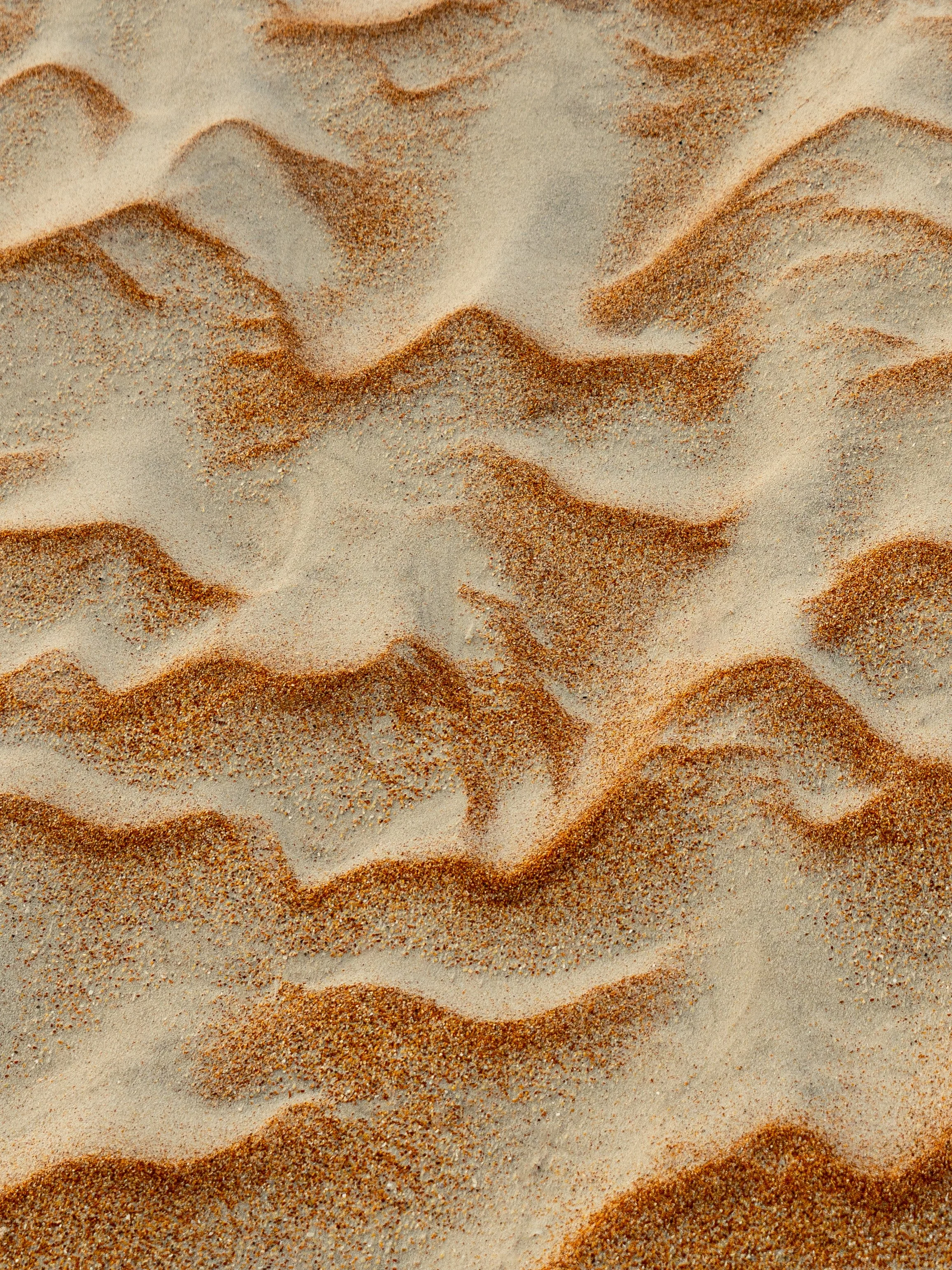 Photo of patterns shaped by the wind in beach sand. Photograph taken on Crescent Beach near St. Augustine, Florida.