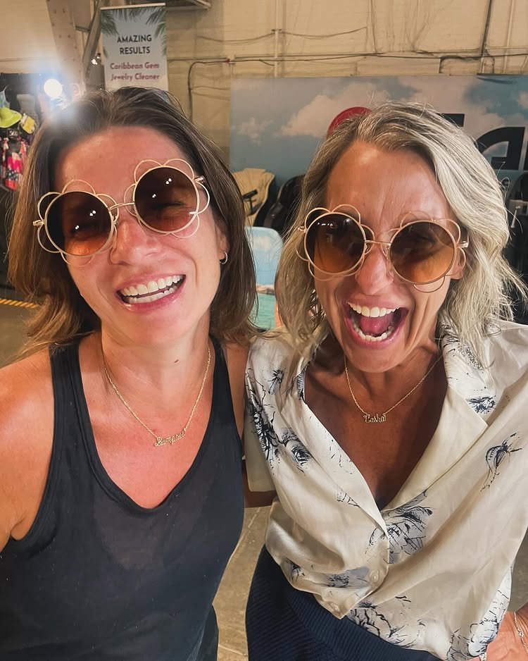 Happy woman wearing a statement handcrafted wire necklace with personalized name and birthstone charms.