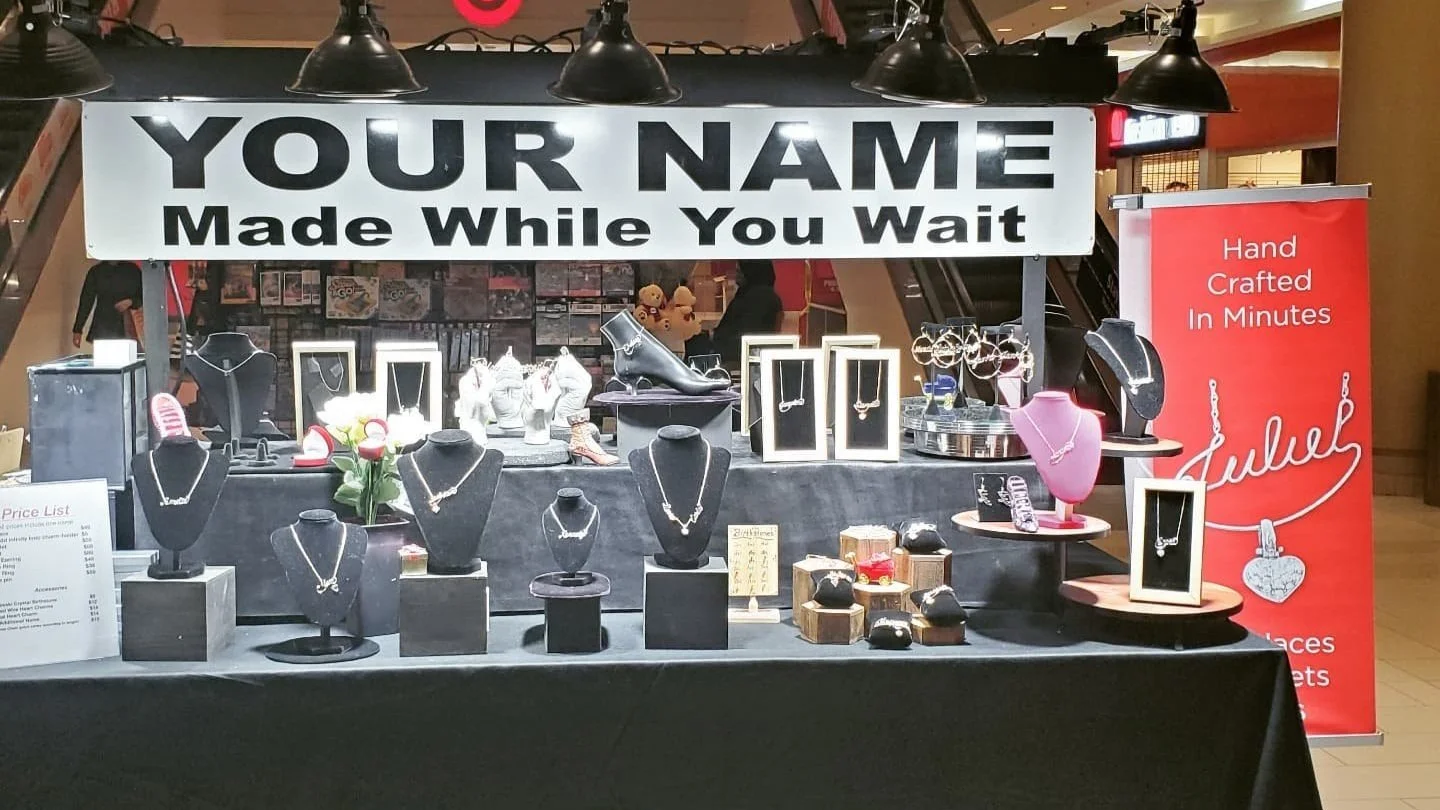 Custom wire jewelry display featuring handcrafted personalized pieces.