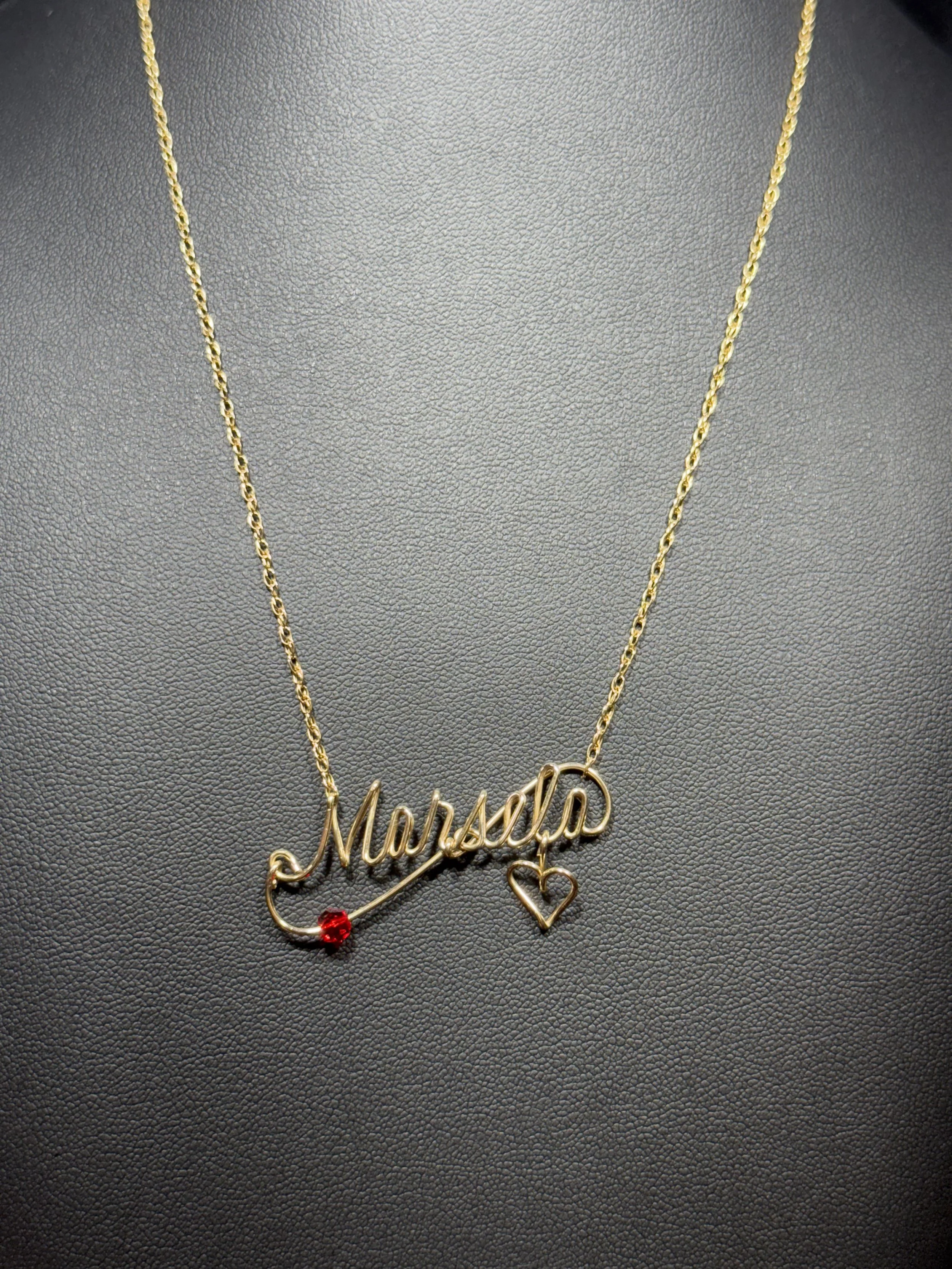 Handcrafted wire necklace featuring a personalized name charm.