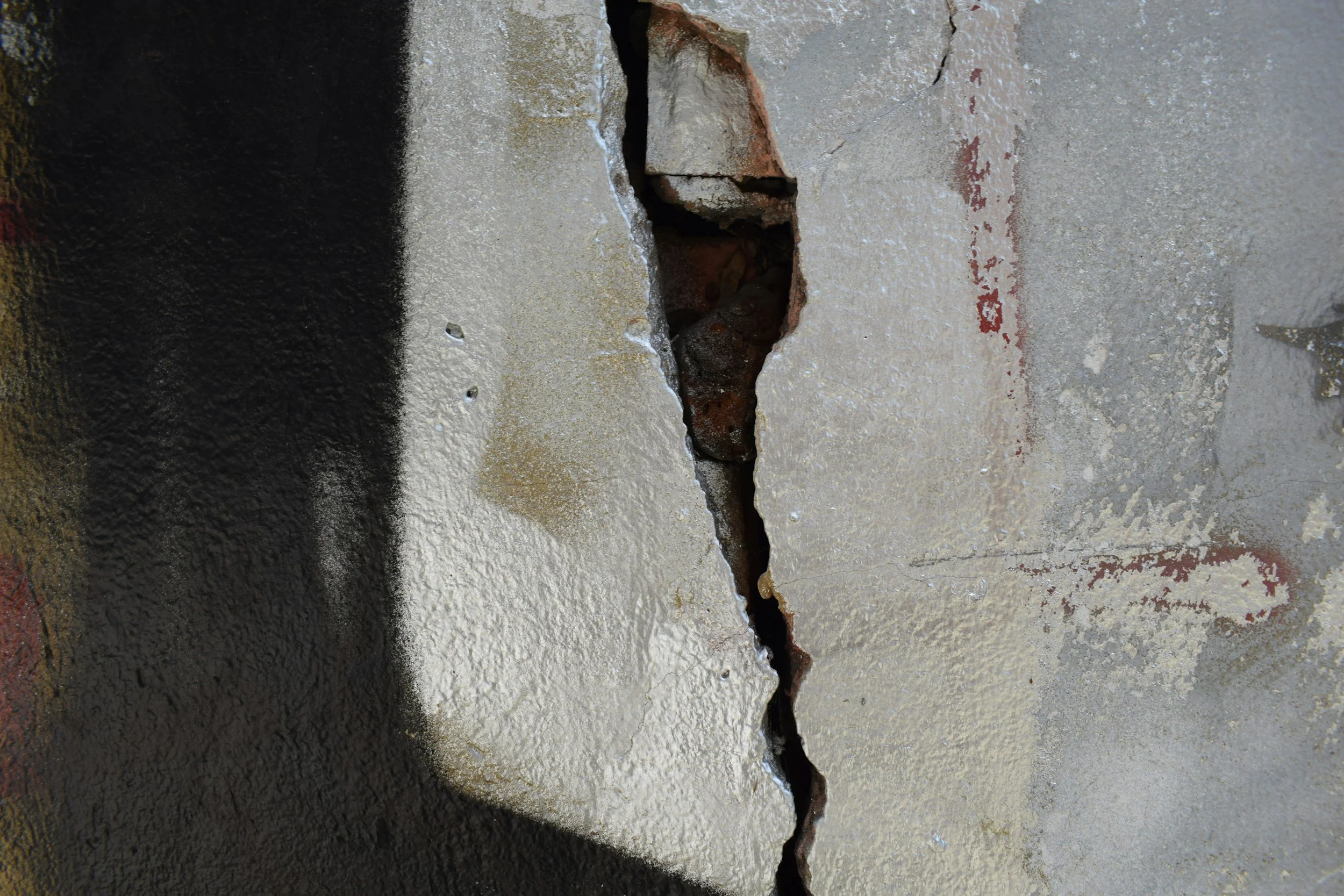 Close-up of a fractured engine block surface showing material failure attributed to a design defect