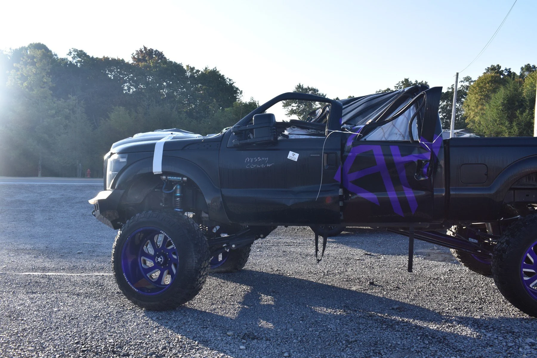 Line drawing of a pickup truck showing forces acting on the vehicle, including brake and normal forces on both axles, with measurements and angles labeled.