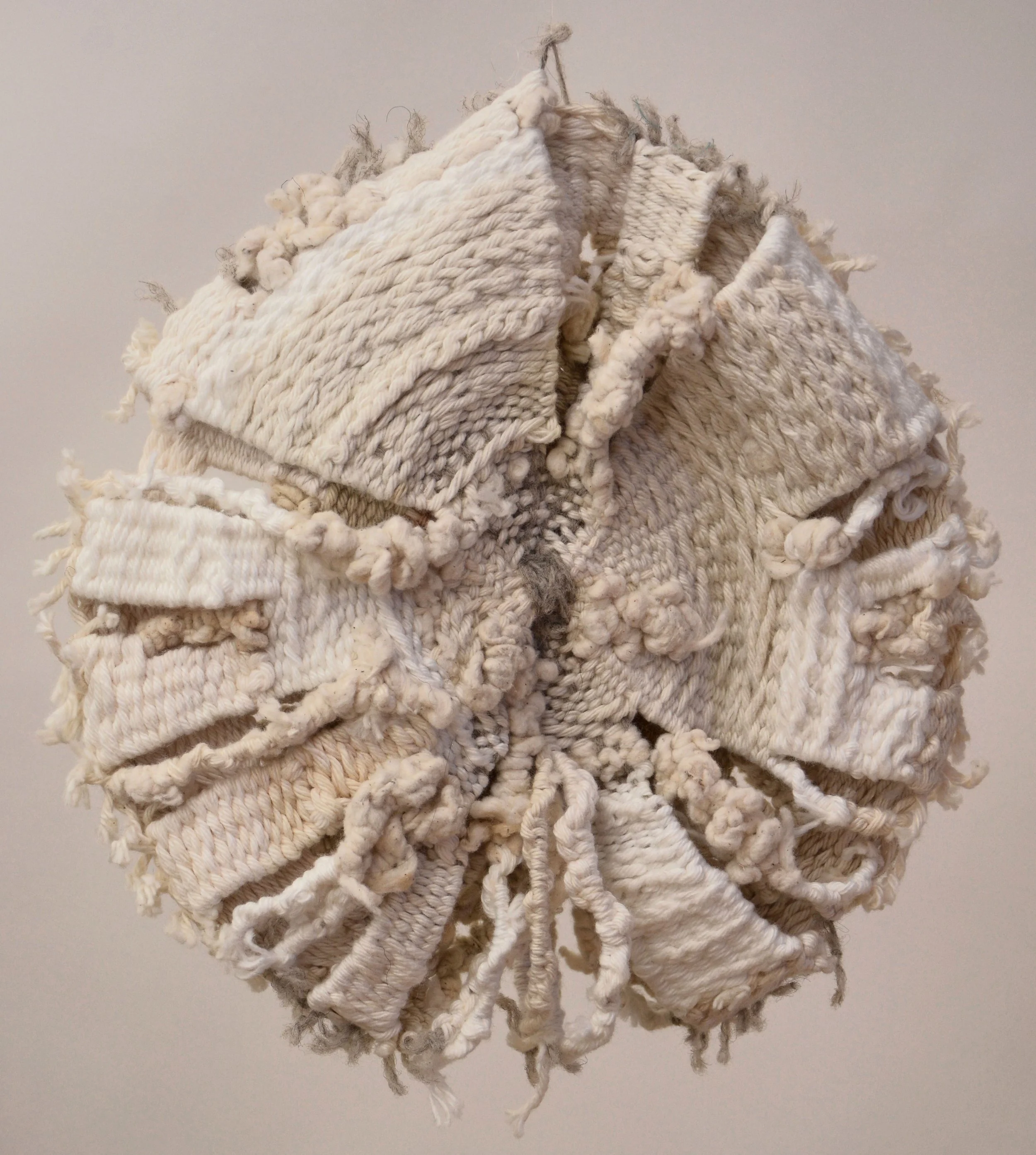 Textile art sculpture with intricate weaving and knots