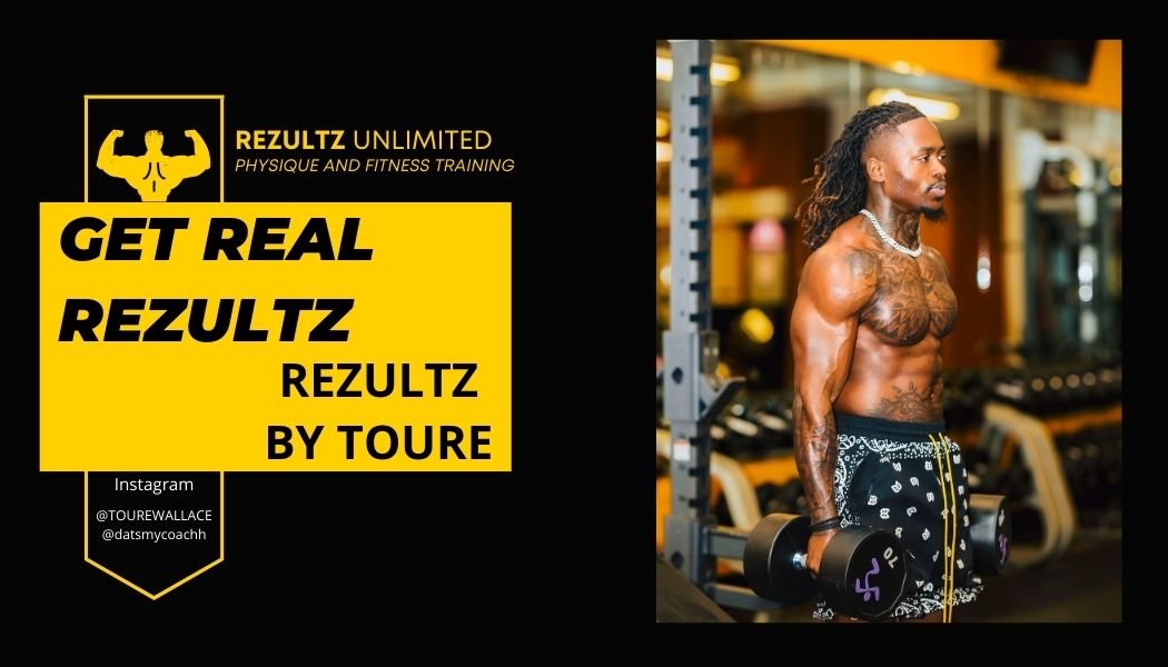 A muscular man with long hair and tattoos, wearing black shorts with white patterns and a necklace, is working out in a gym while holding dumbbells in each hand. The gym has a yellow and black color scheme.