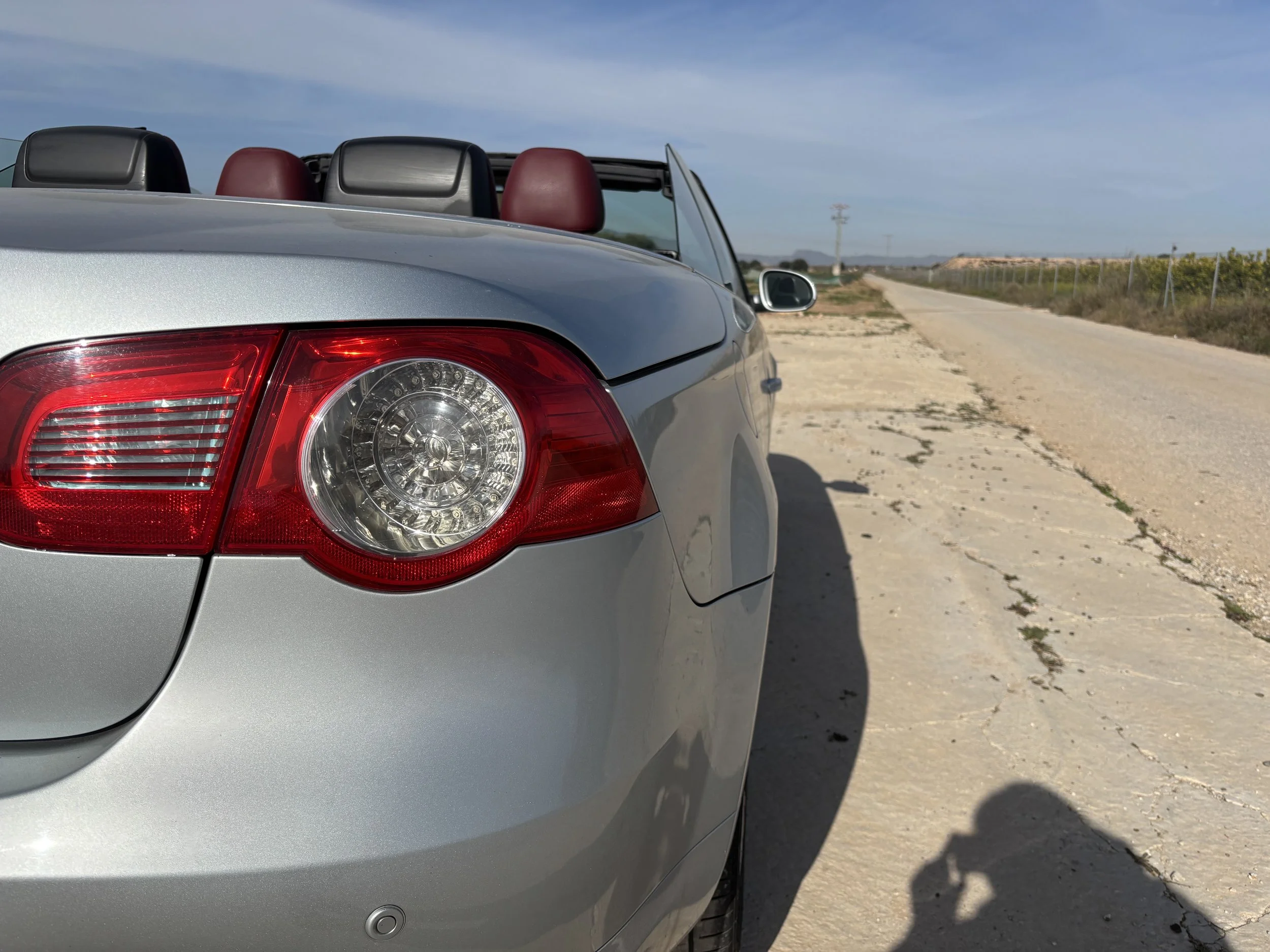 Side-by-side comparison of two vehicle interiors, showing the front seats with the driver's side on the left and the rear seats on the right. The vehicle on the left has two front seats, a dashboard, and a steering wheel, while the vehicle on the right has a back bench seat with three headrests.