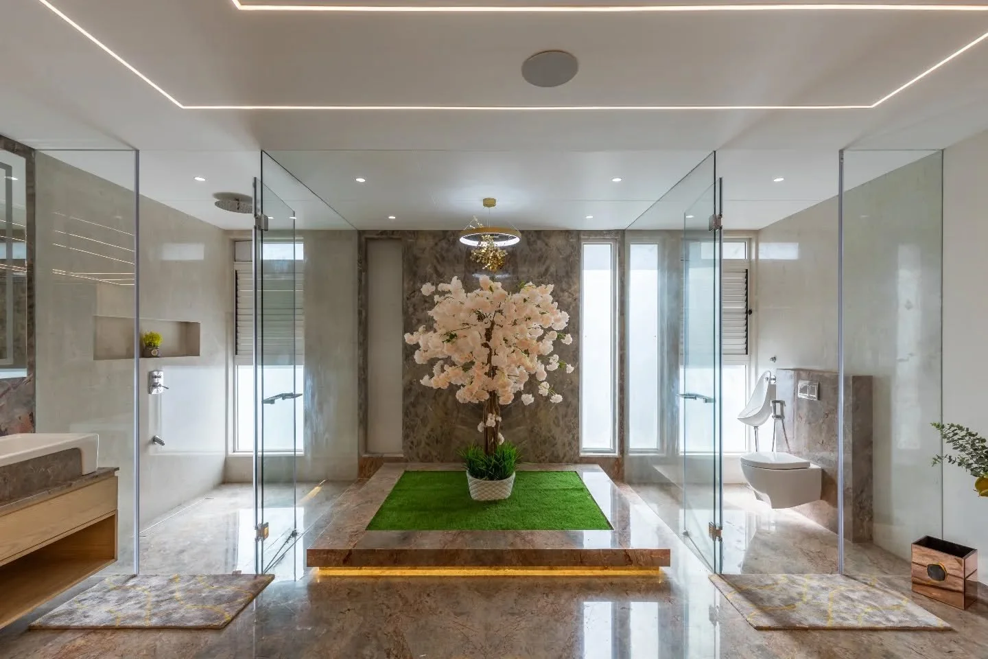 Even reflections deserve architecture. The bathrooms here are crisp &mdash; glass, marble, and geometry doing all the talking. Muted greys, warm beige, a pop of mustard &mdash; nothing forced, everything balanced. They feel like the kind of spaces th