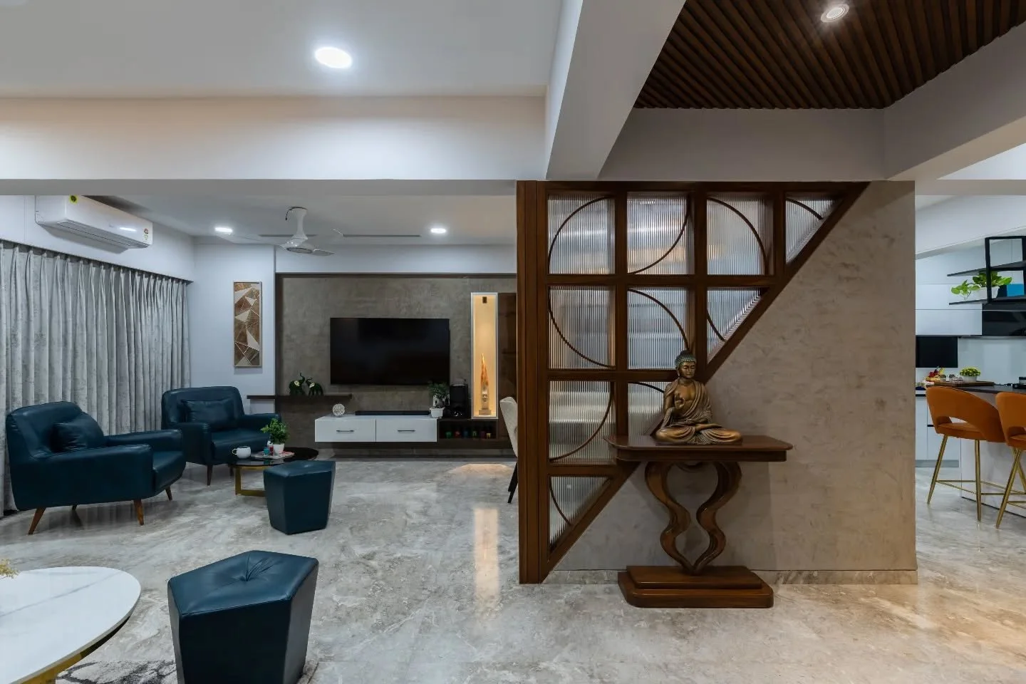 This home layers wood, light, and colour with quiet confidence &mdash; tan and teal seating shaping the living room, a white dining zone keeping the rhythm smooth, and a bright kitchen punctuated by orange bar stools. The bedrooms stay neutral and ca