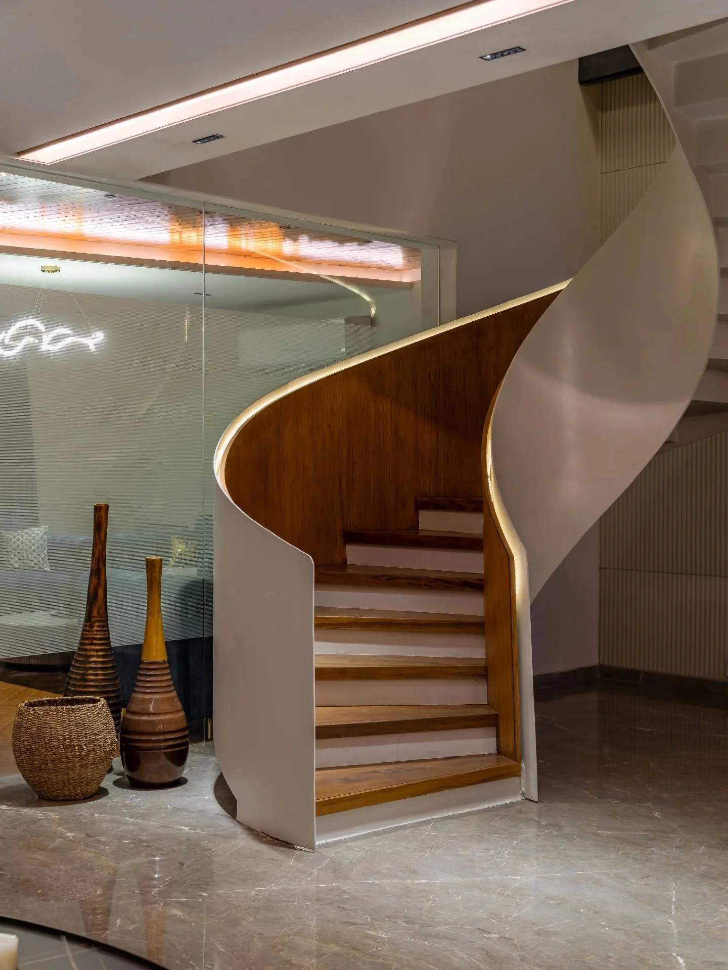 This house is less about statements and more about continuity. Milky white walls let colour arrive gently&mdash;sky blue seating, a hint of yellow, warm wood underfoot. Spaces connect without urgency, stitched together by light and proportion. The st