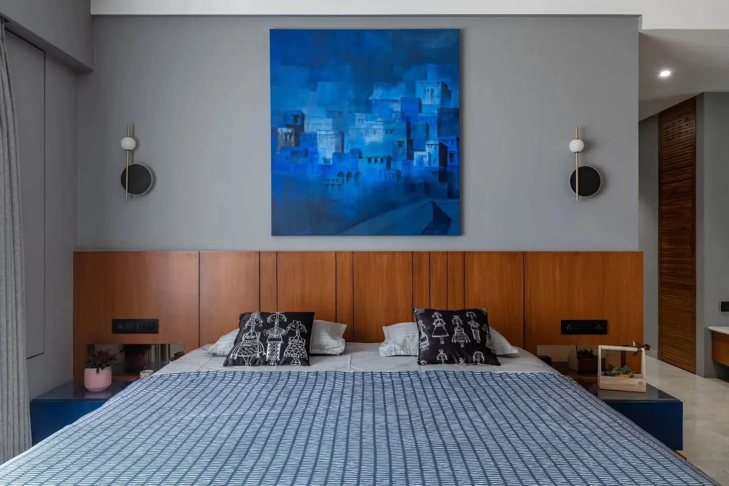 Each bedroom holds its own identity without straying from the home&rsquo;s language. Grey and wood echo the cosiness of the TV lounge, punctuated by indigo art. Another space explores teal with subtle trim detailing and light wood balance. The kids&r