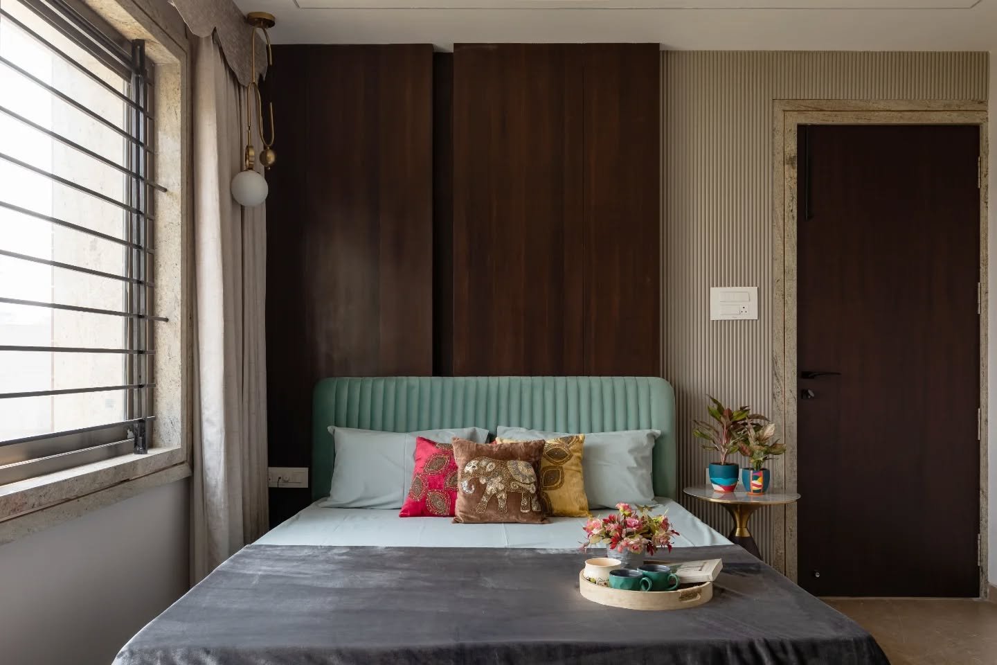 The bedrooms refuse uniformity, and that&rsquo;s their strength. One leans into cream and wood restraint, another softens milky white with patterned blue and glints of gold. A darker suite explores black and metallic drama, while deep blue and pink v