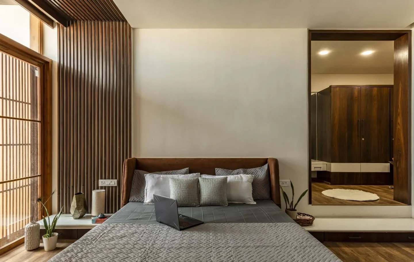 The bedrooms stay consistent in tone but not in experience. Wood takes the lead&mdash;through bedbacks, shelves, and quiet study corners that feel built-in rather than added. Each room holds its own rhythm, with display niches and workspaces placed w